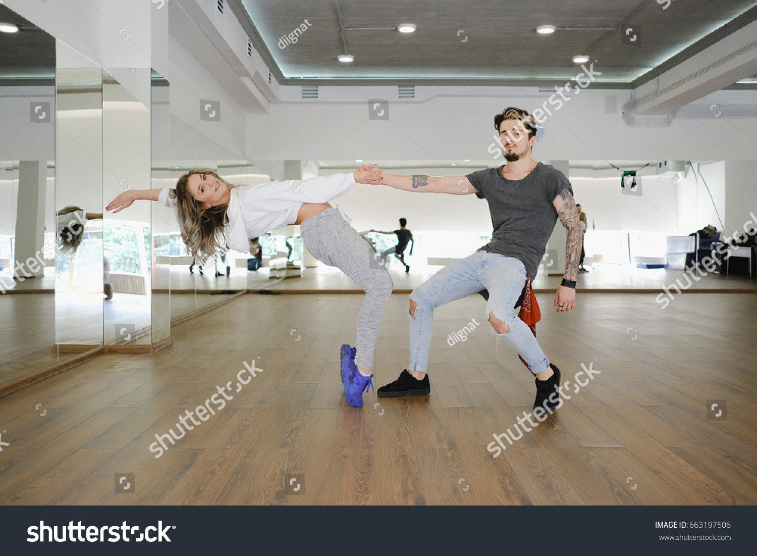 Young modern dancers dancing in the studio. Sport, dancing and urban culture concept #663197506