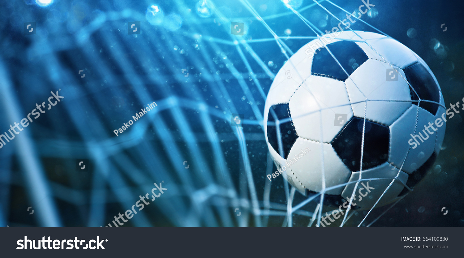 Soccer ball in goal on blue background #664109830