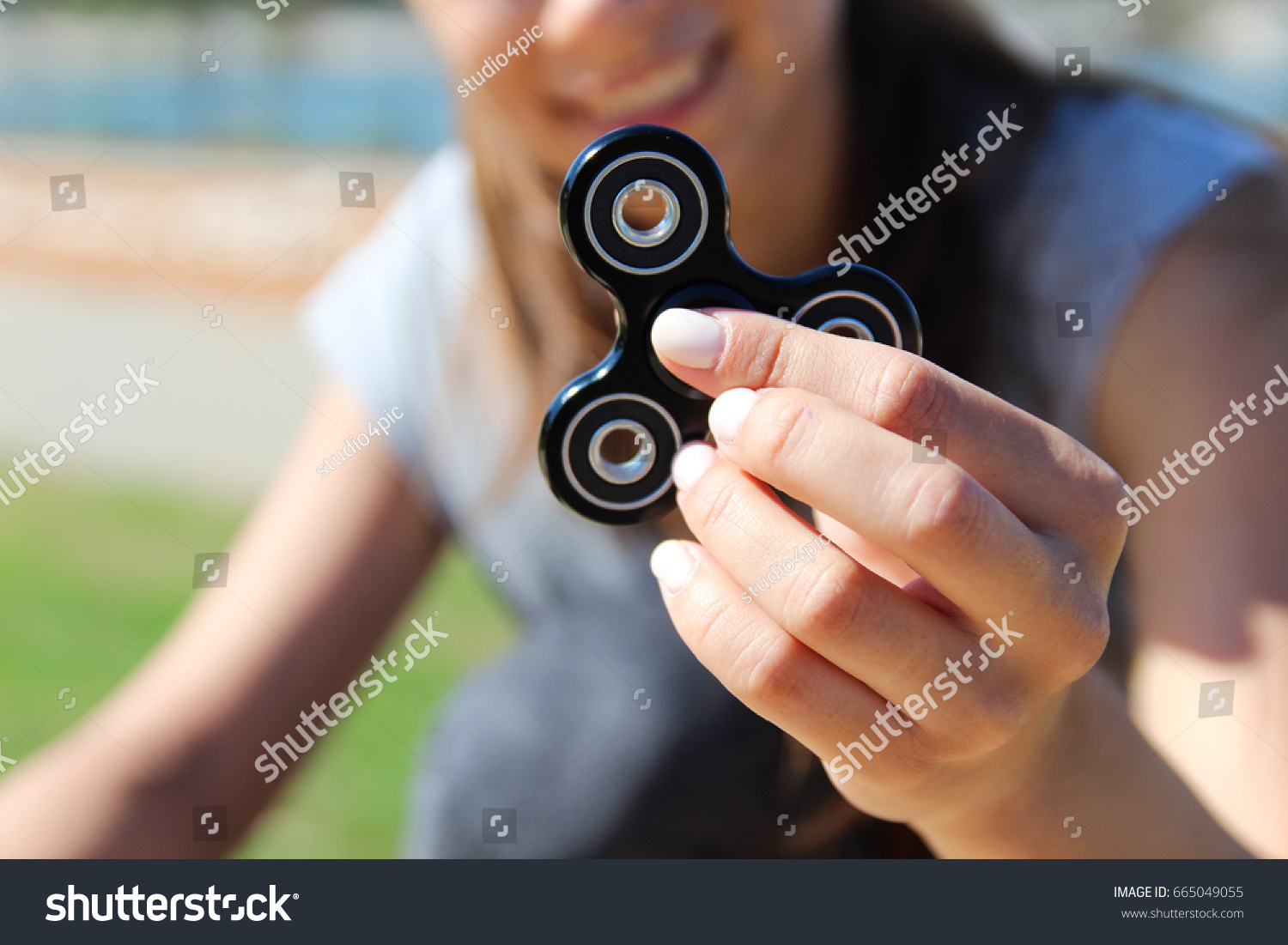 Women and men hold a white and black spinner  #665049055