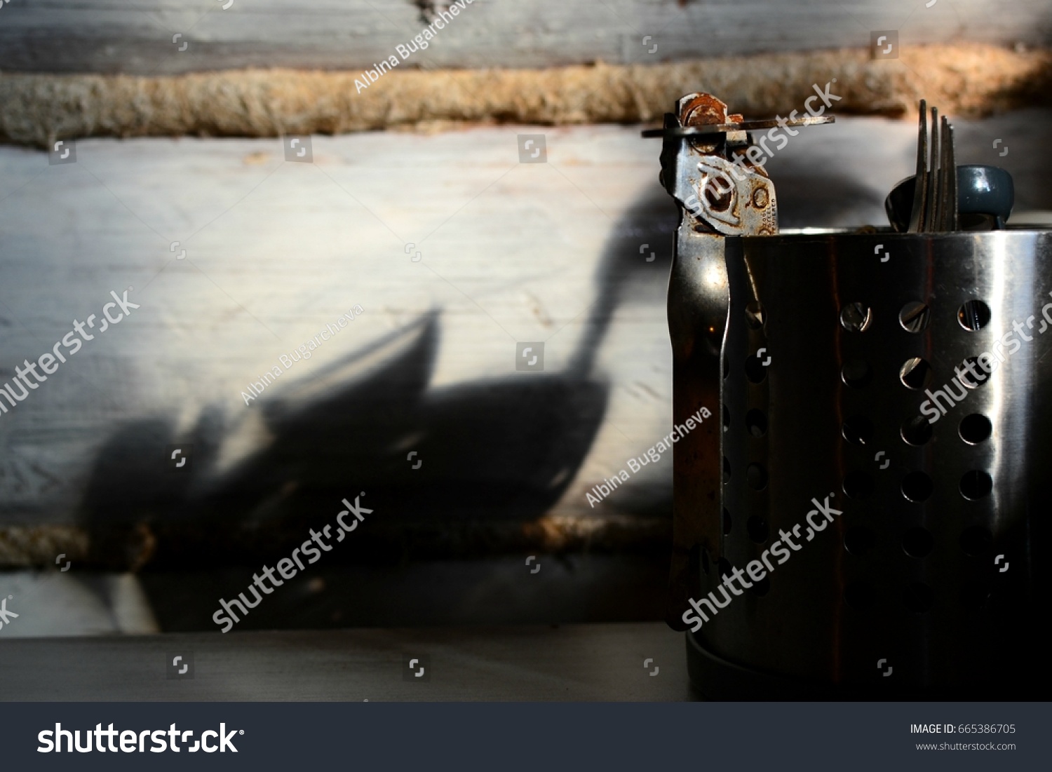 Rusty can opener in a metal pot  #665386705
