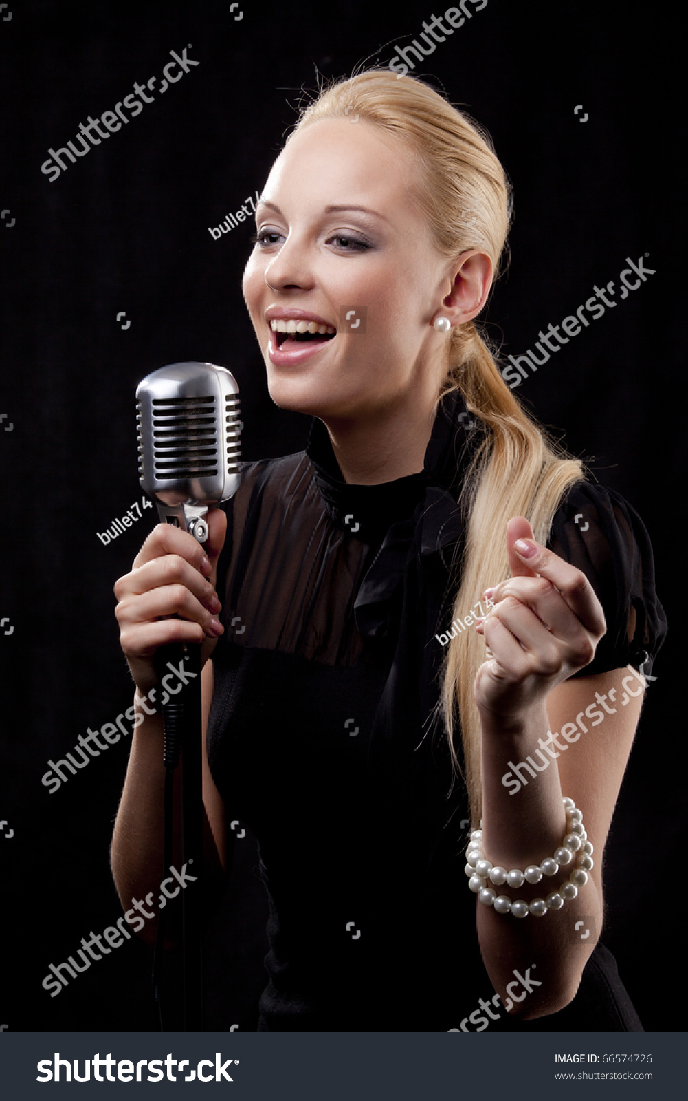An elegant female singer with microphone #66574726