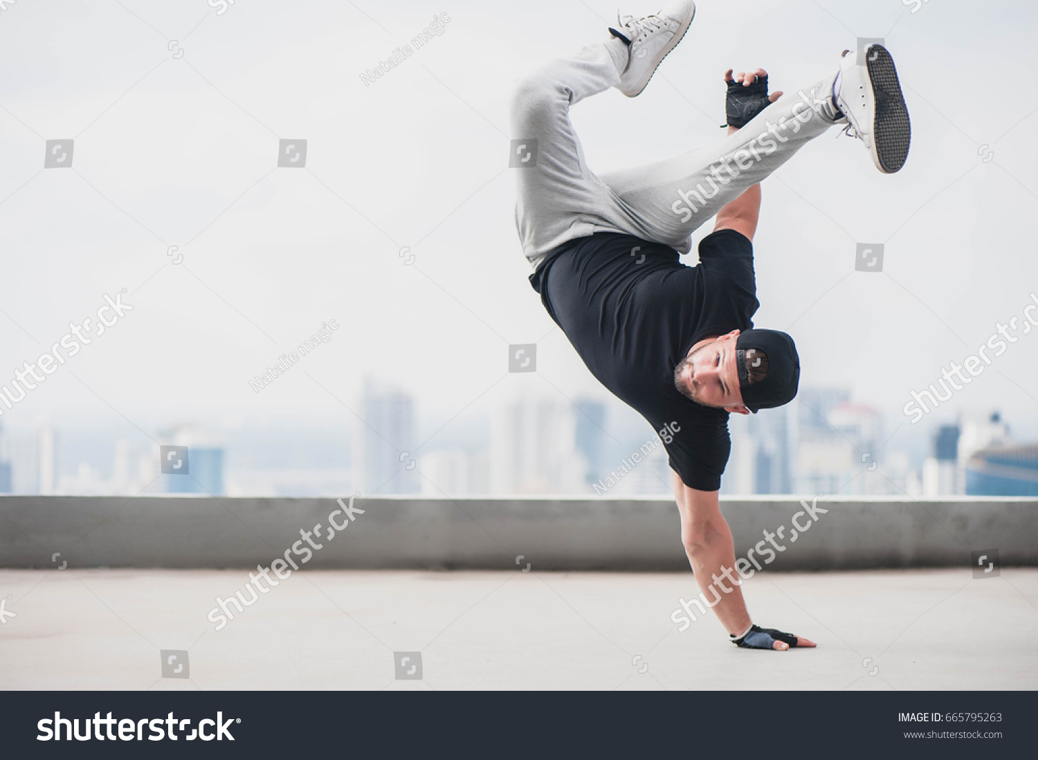 Bboy doing some stunts - Street artist breakdancing outdoors #665795263