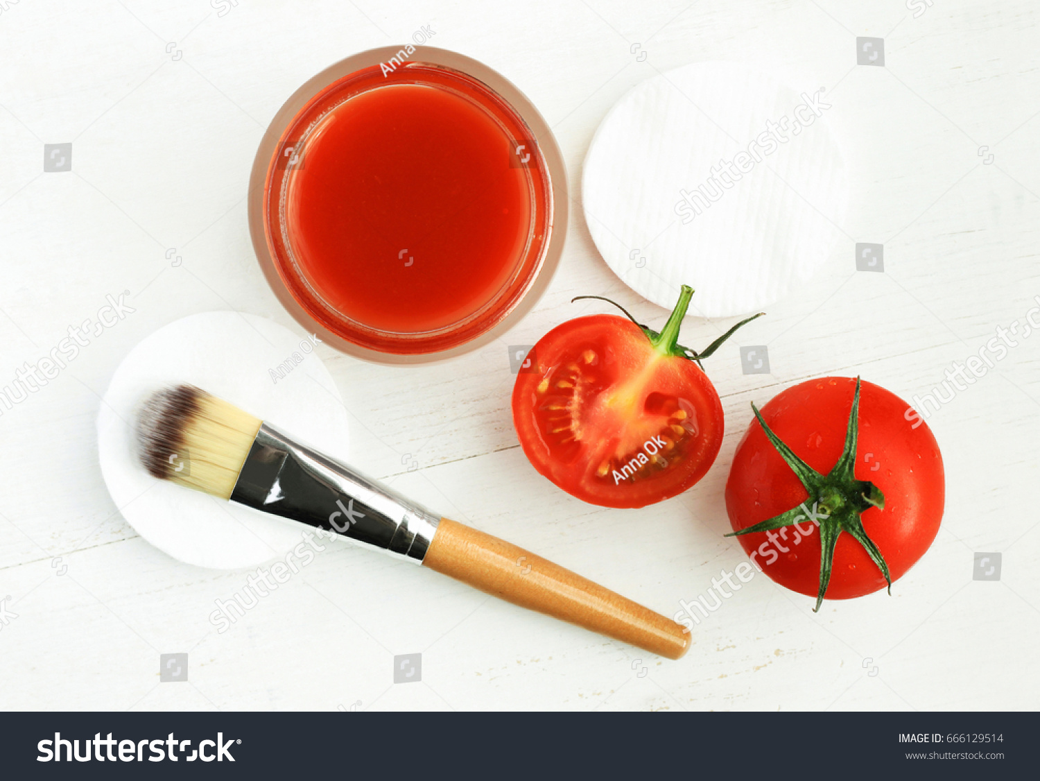 Tomato face mask for natural beauty care. Jar of juicy paste, red fresh fruit, applicator brush, top view white wooden background preparation homemade cosmetic   #666129514