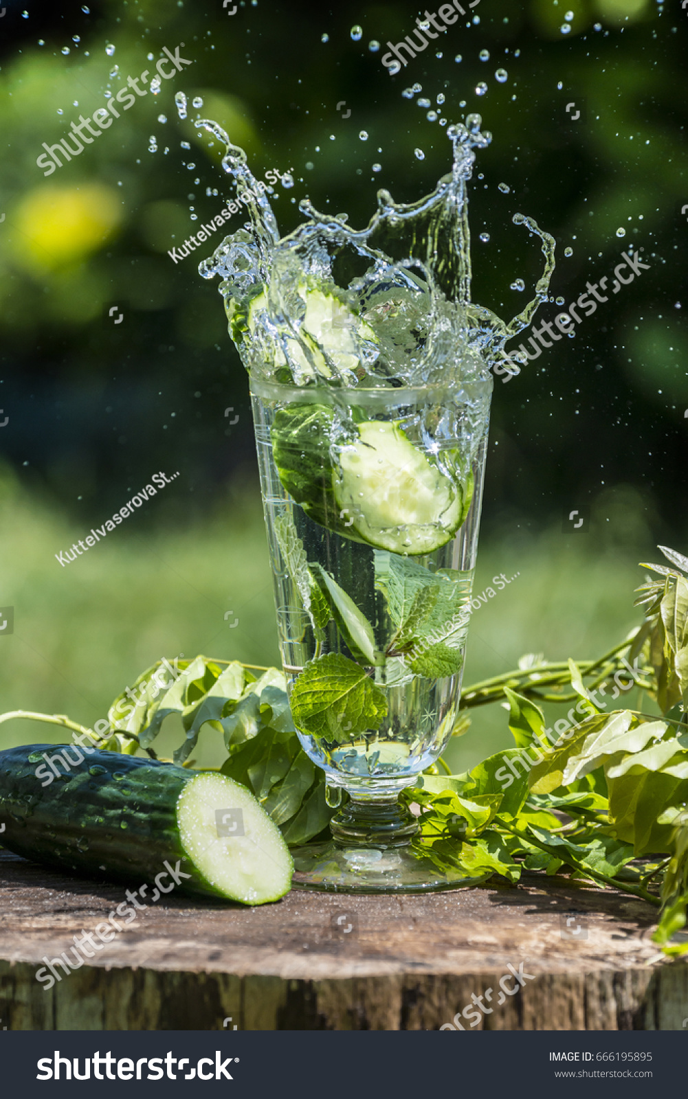 Glass with mineral water with cucumber and mint - home made lemonade #666195895