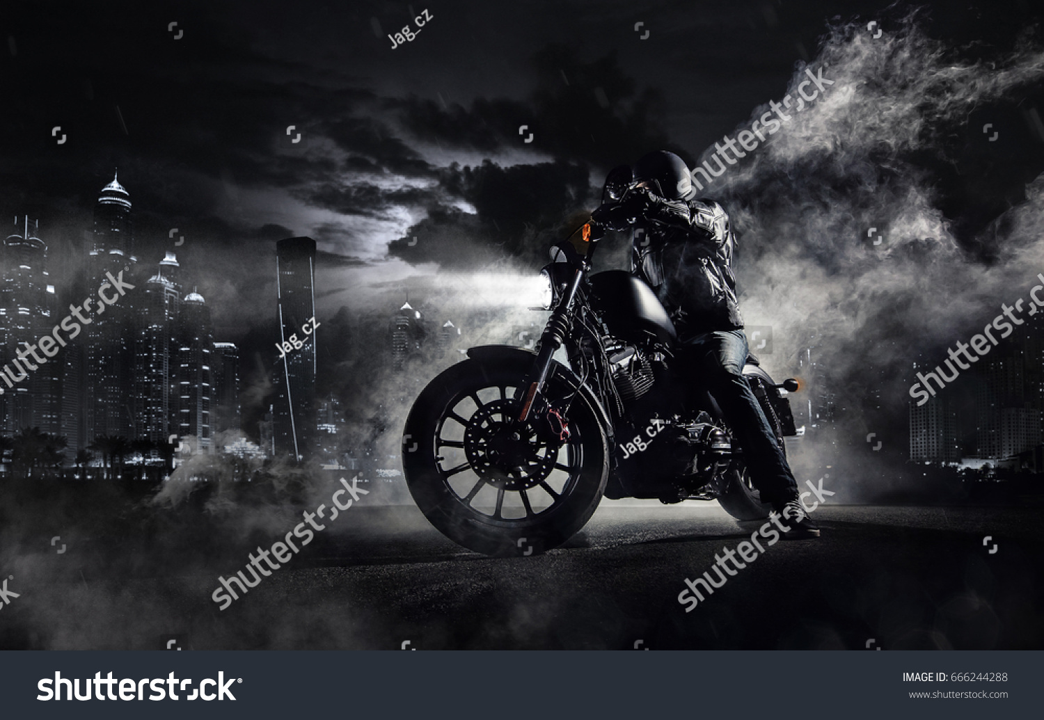 Detail of high power motorcycle chopper with man rider at night. Modern city of Dubai and fog with backlights on background. #666244288