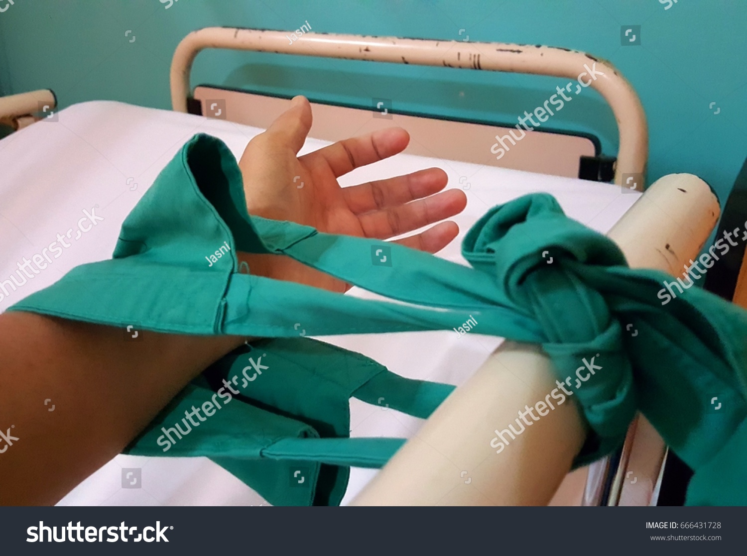 Close up image of patient hand restraint on hospital bed. #666431728