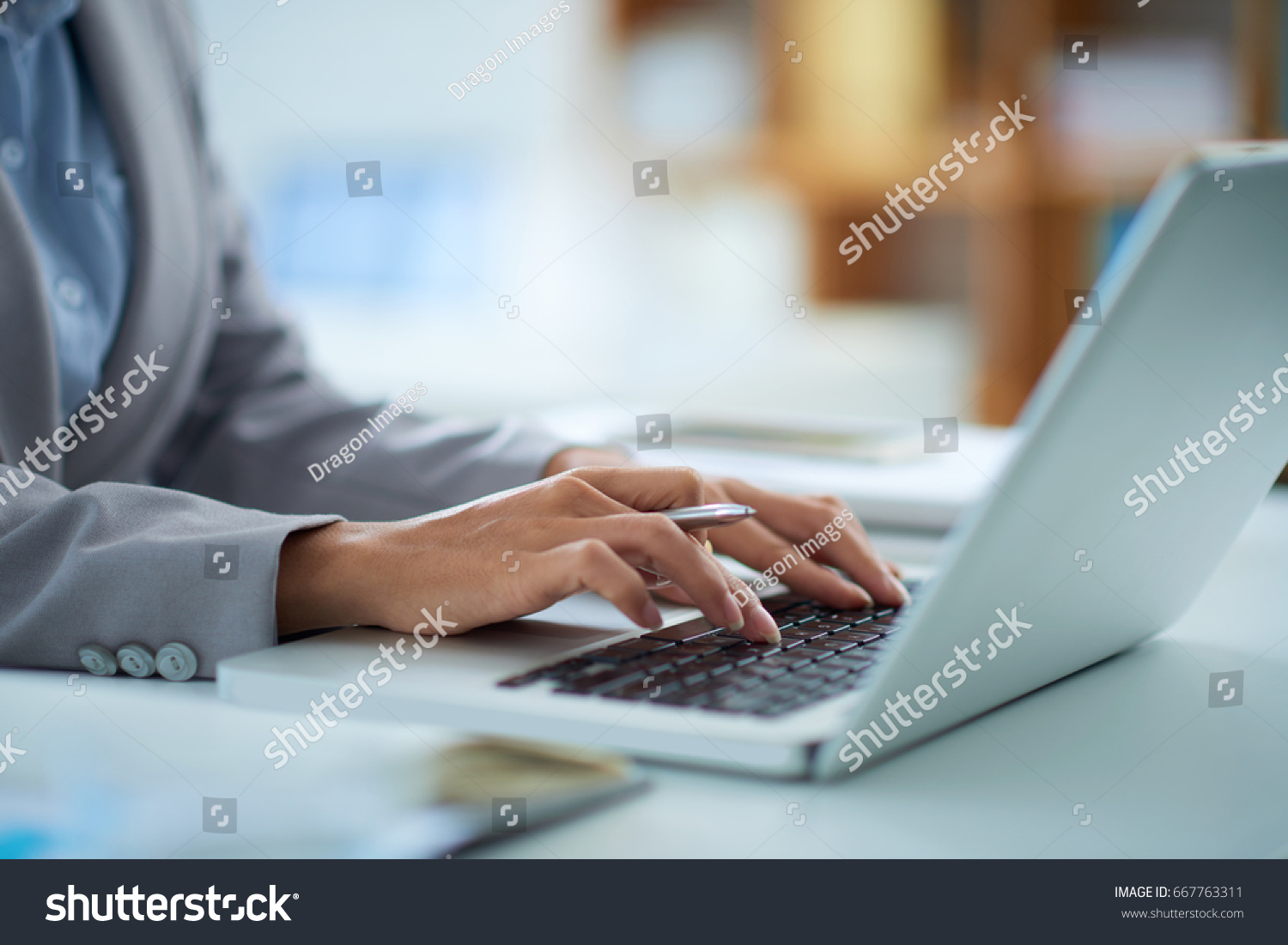 Hands of business lady working on laptop #667763311