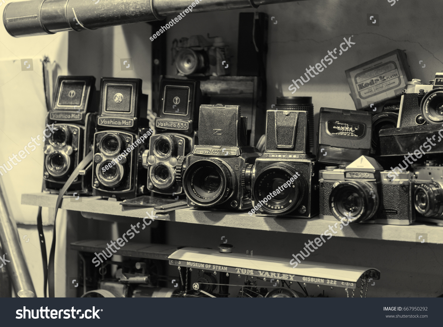 london, england, 10/05//2017 An old bronica, kiev, yashica and pentax retro vintage film photography camera collection, on a shelf in an old antique shop. #667950292