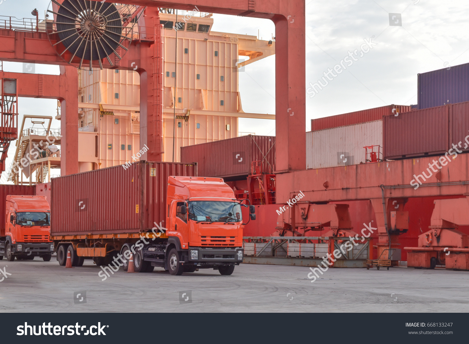 Seaport operation, container discharging from vessel. Truck picking up container from vessel. #668133247