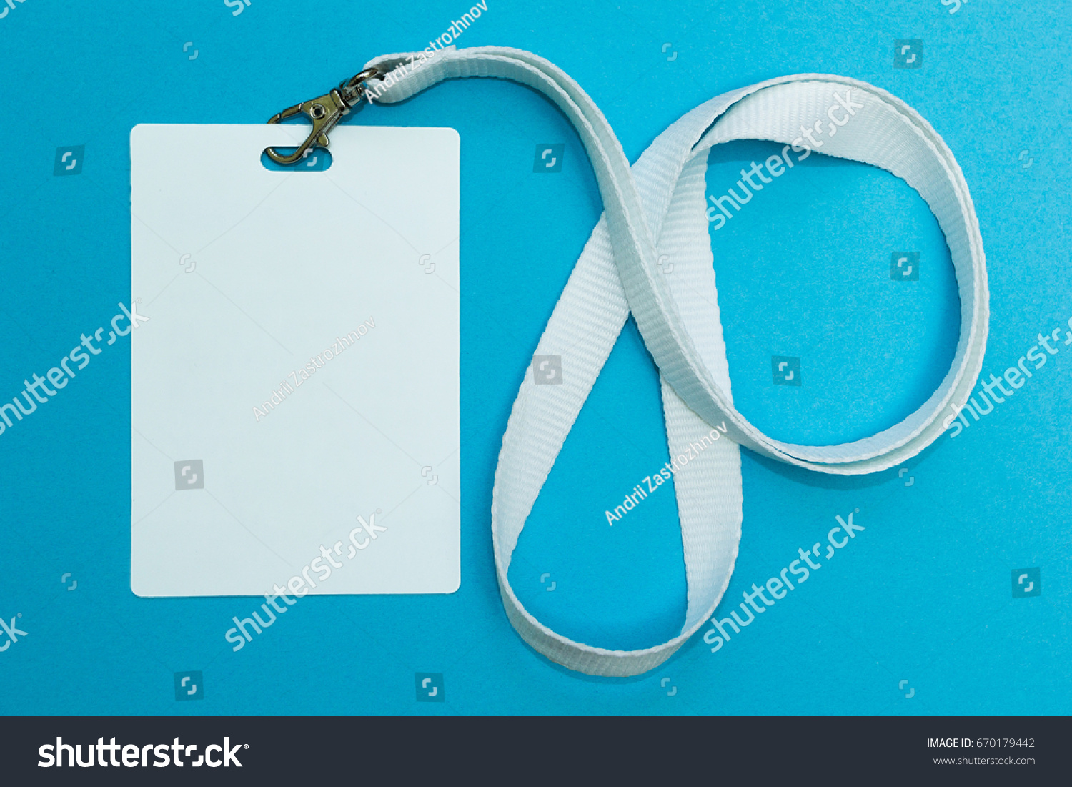 Blank badge mockup isolated on blue. Plain empty name tag with string. #670179442