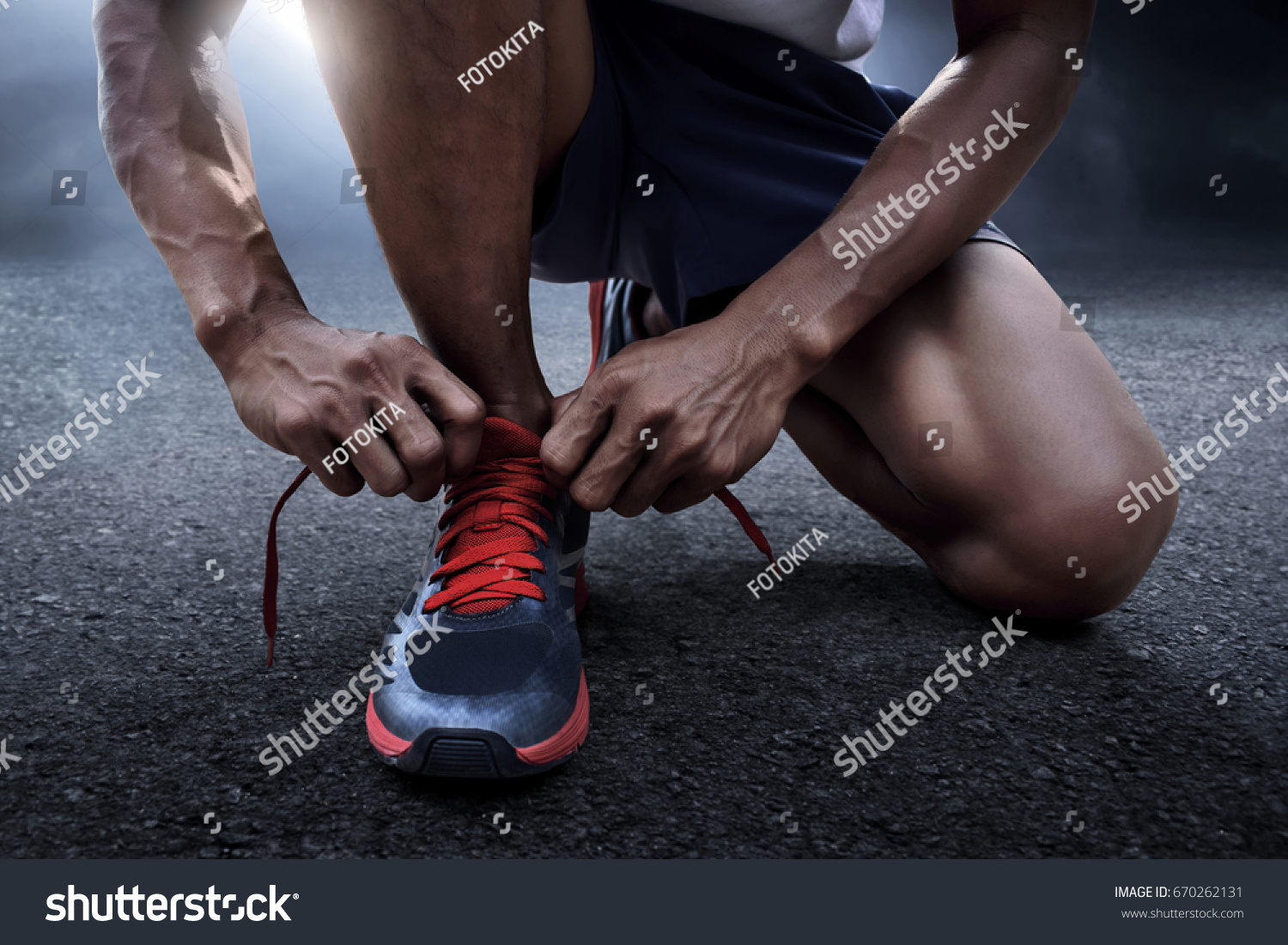 Man tying running shoes #670262131