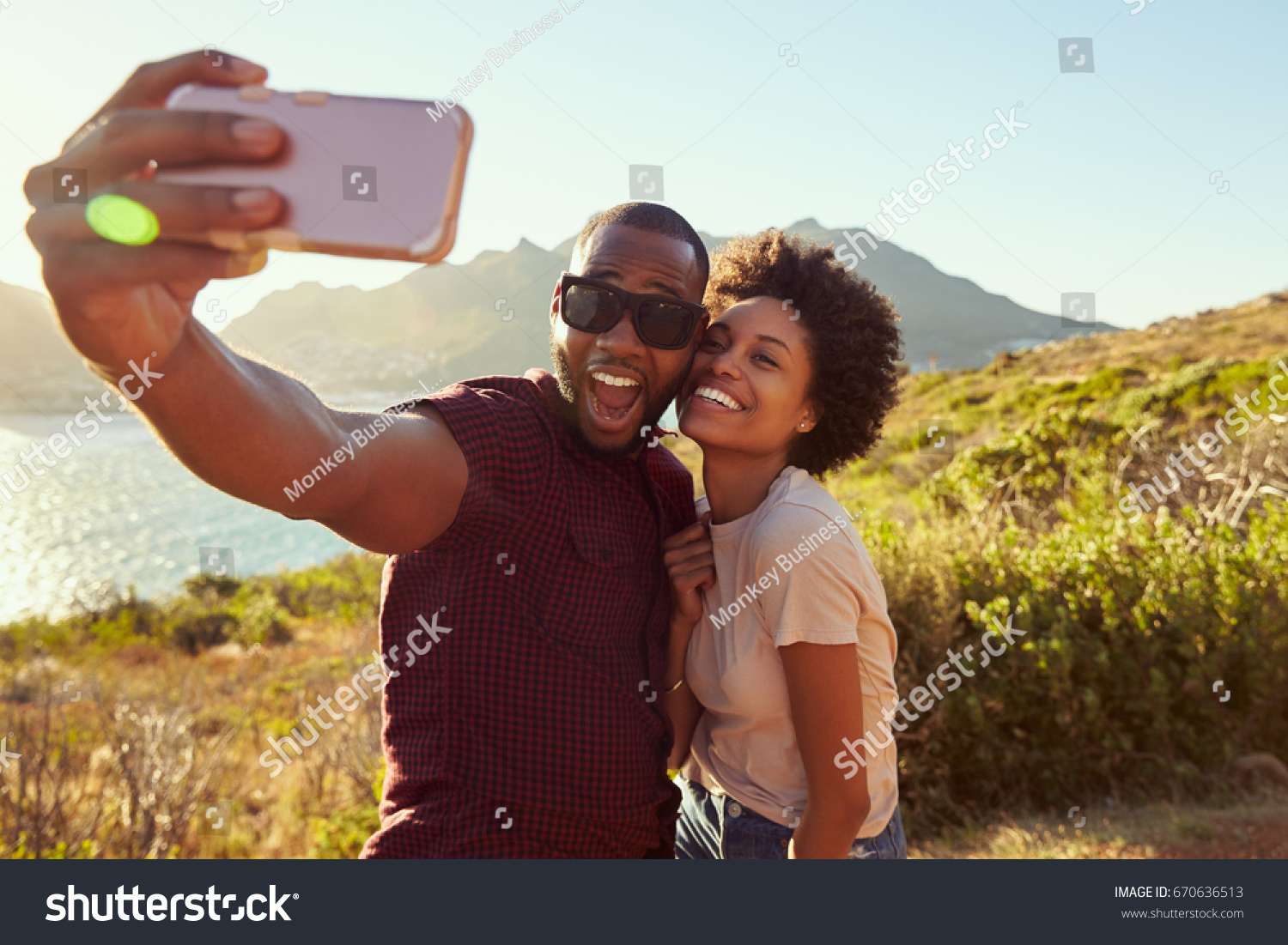 Young Couple Pose For Holiday Selfie On Clifftop #670636513