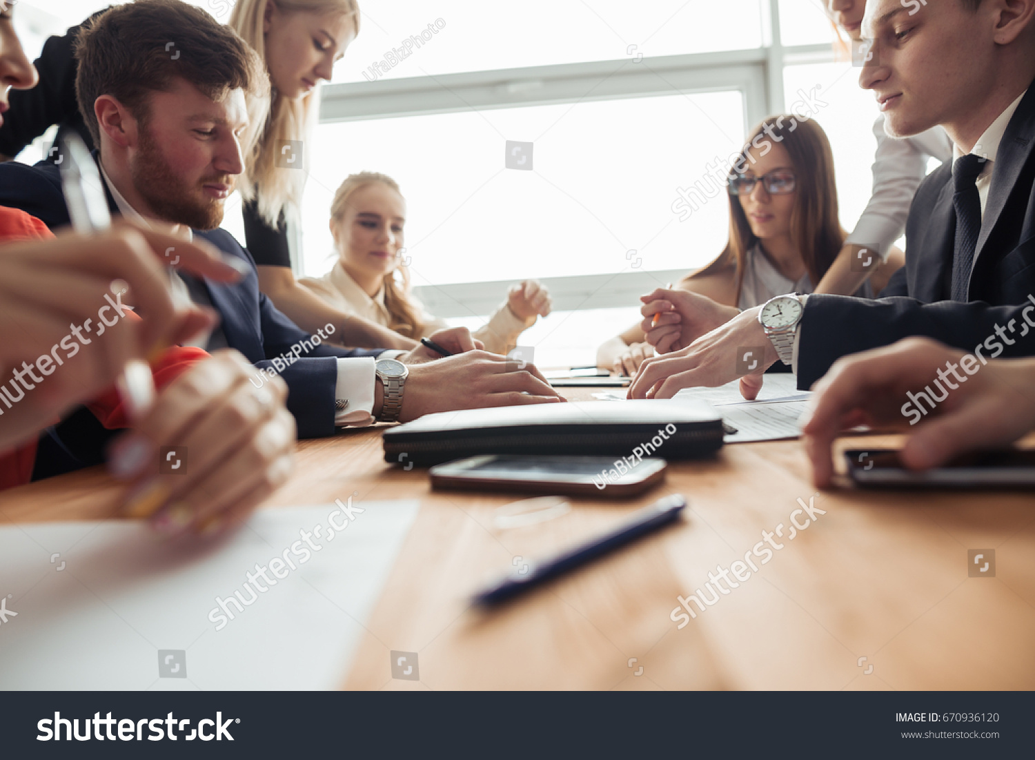 Businesspeople discussing together in conference room during meeting at office #670936120