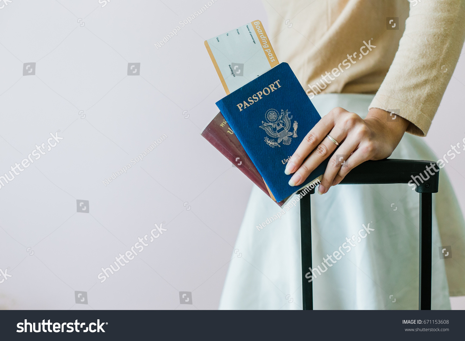 Closeup of girl holding passports and boarding pass #671153608