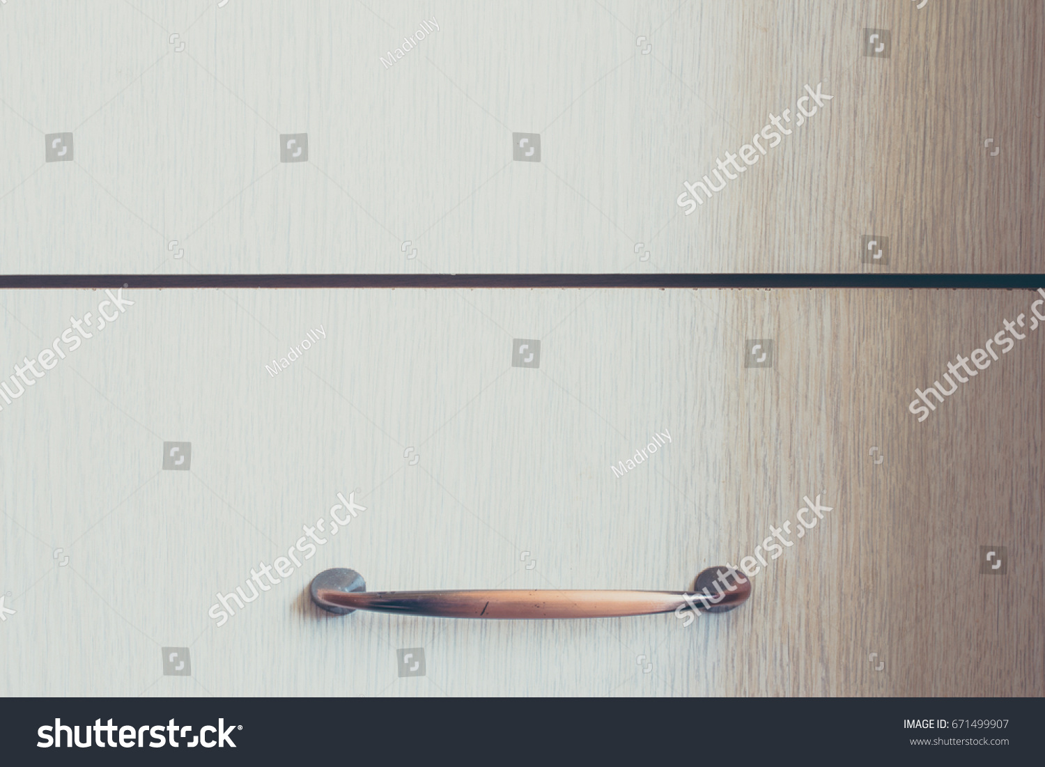 Wood texture background. Closeup to handle of a furniture. #671499907
