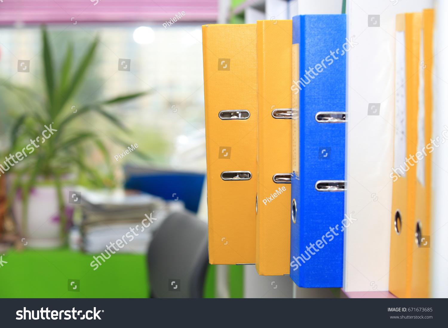 Folders in office. Folders on office window background. #671673685