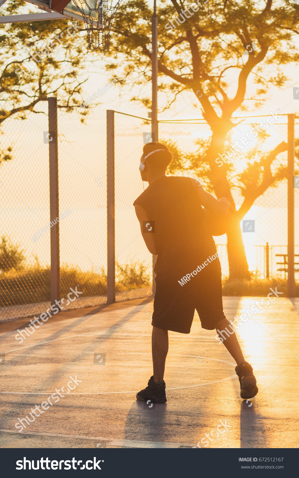 young black handsome man playing basketball on sunrise, morning sports, healthy lifestyle, having fun,  #672512167
