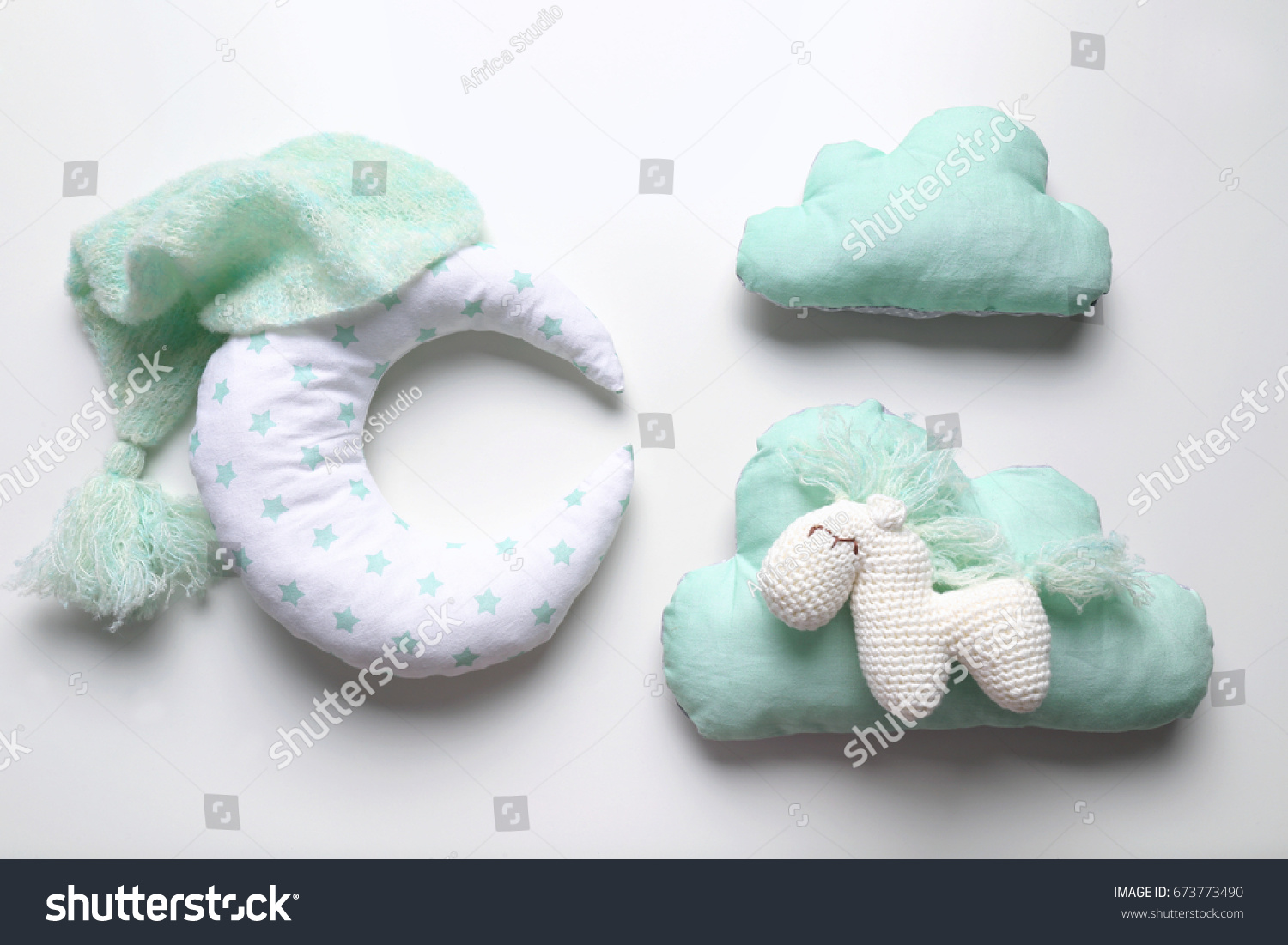 Adorable crochet toy with baby clothes and pillows isolated on white #673773490