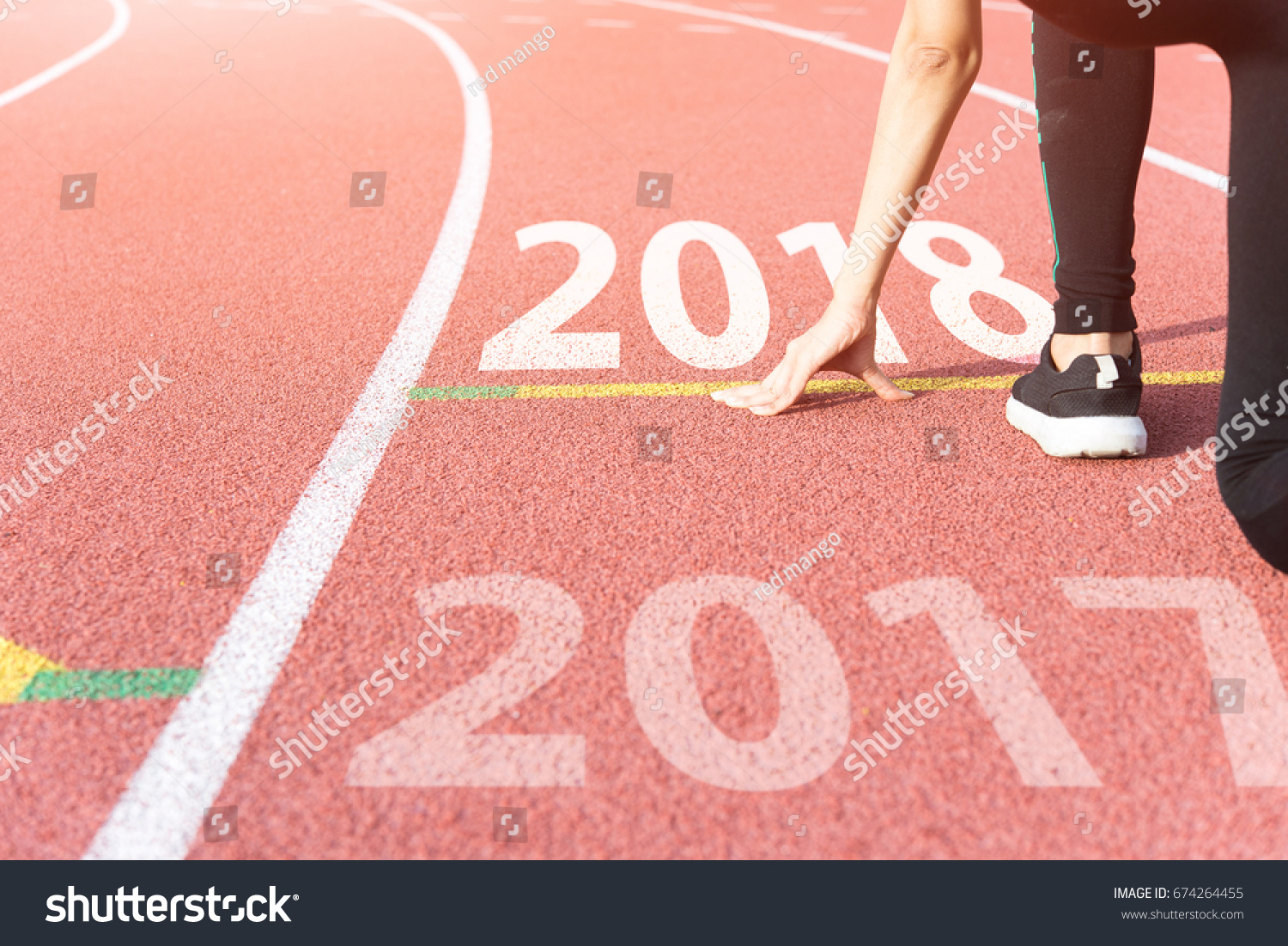 Athlete on Starting line waiting for the start in running track with text 2017 year, Start to new year #674264455