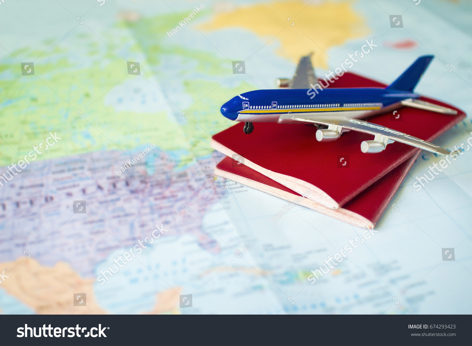toy aircraft with two neutral passports on the map, travel concept, flight to america, trip by plane. pasport and plane on world map #674293423
