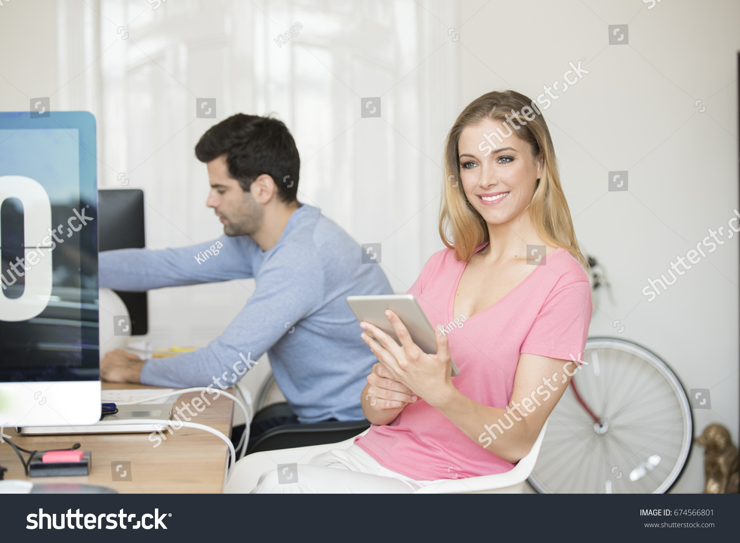 Shot of a young businesswoman using digital tablet while sitting at desk in the office.  #674566801