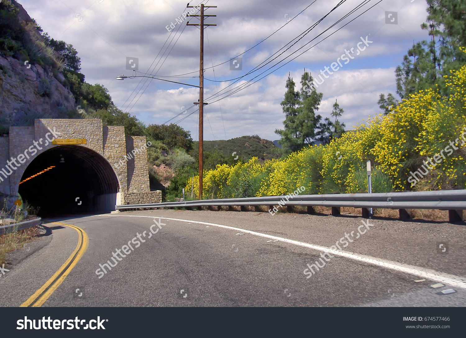 Entrance to Kanan Road tunnel, a Southern California highway surrounded by nature in the Santa Monica mountains recreation area. #674577466