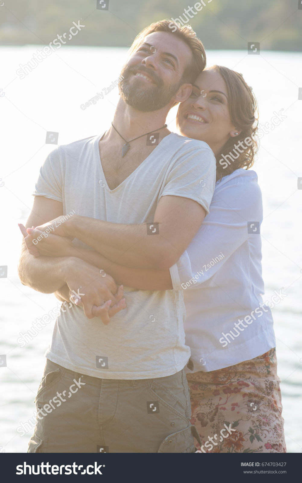 Happy couple have fun outdoor in the park / Happy couple have fun outdoor on the lake #674703427