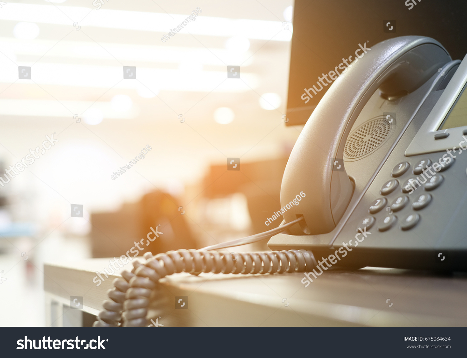 close up soft focus on telephone devices at office desk with light effect,communication technology concept #675084634