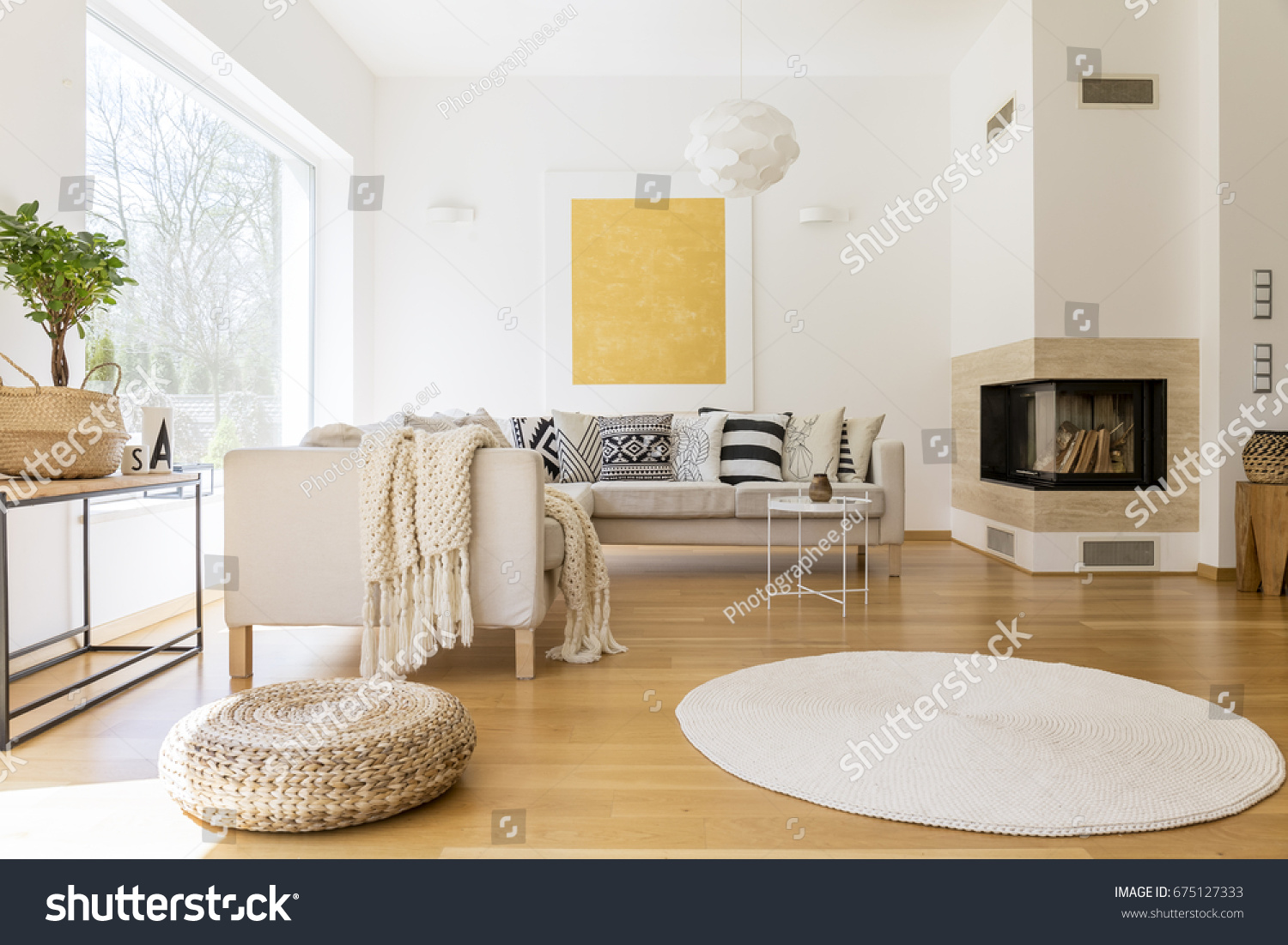 Spacious white and wooden living room with modern fireplace and sofa #675127333