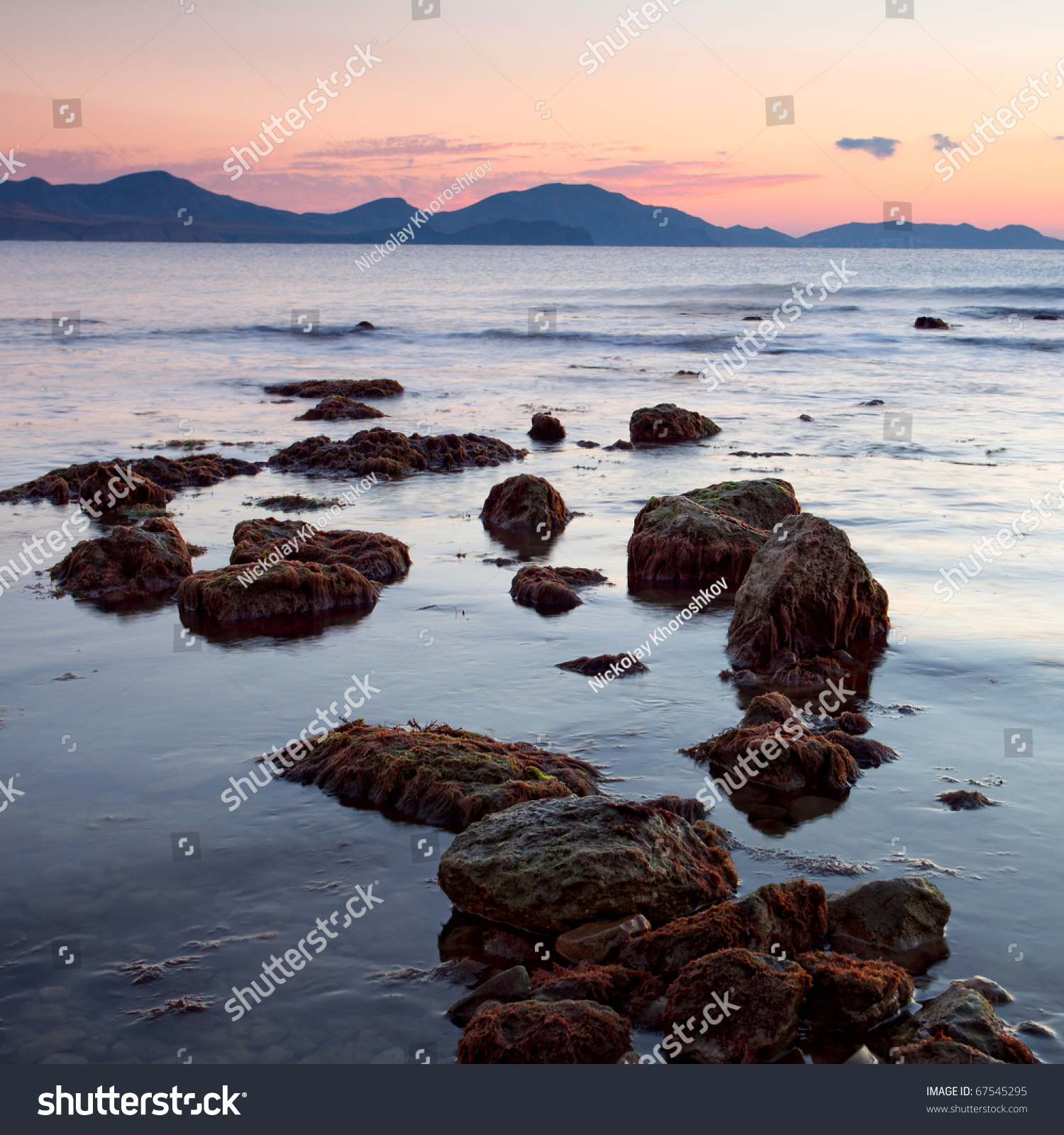 colorful sunrise on the rocky coast of sea #67545295