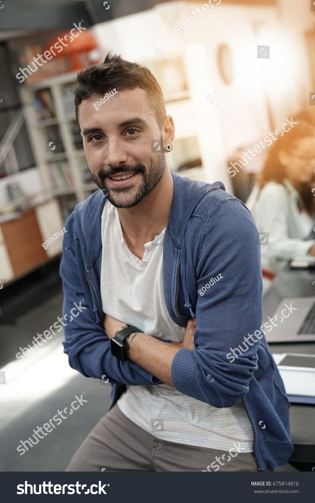 Trendy guy in coworking office with arms crossed #675814816