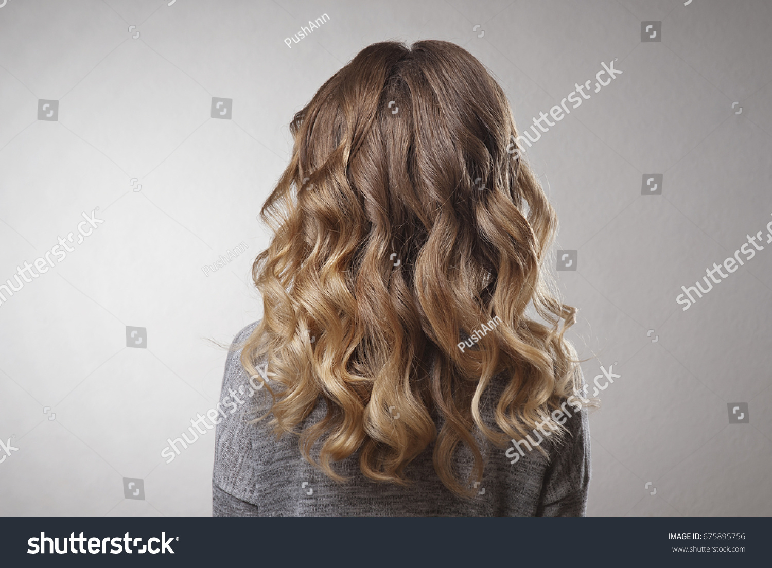 Demonstration of hairstyles long curls on the blonde woman on isolated background #675895756
