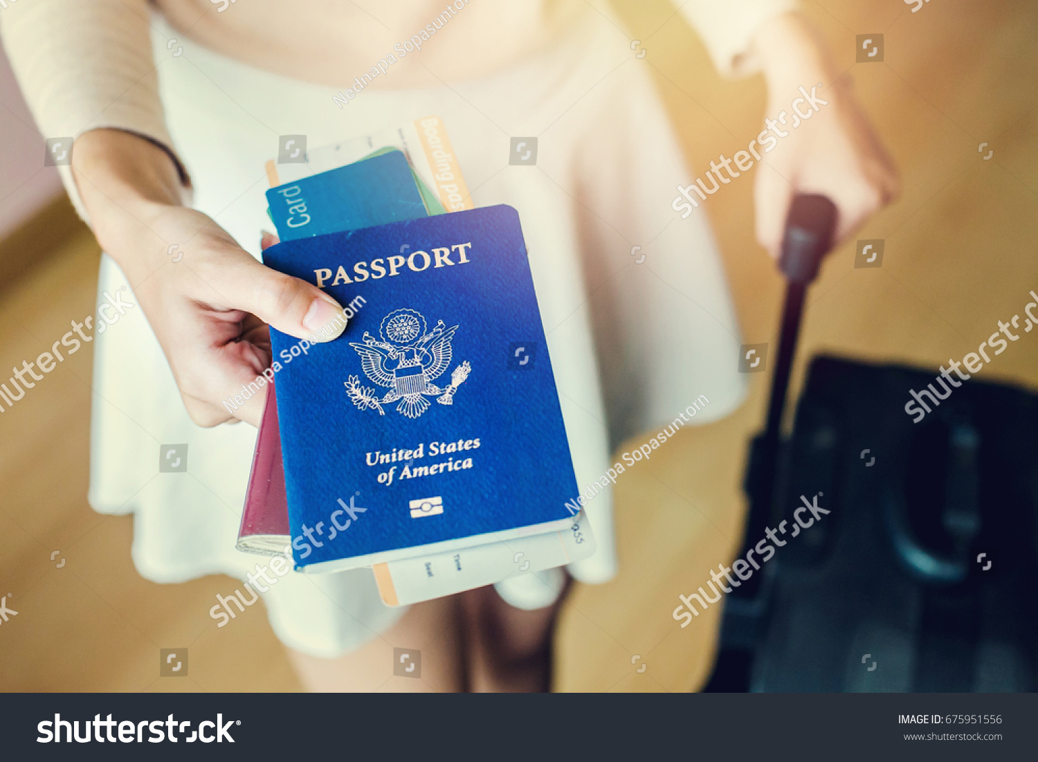 Closeup of girl holding passports and boarding pass #675951556