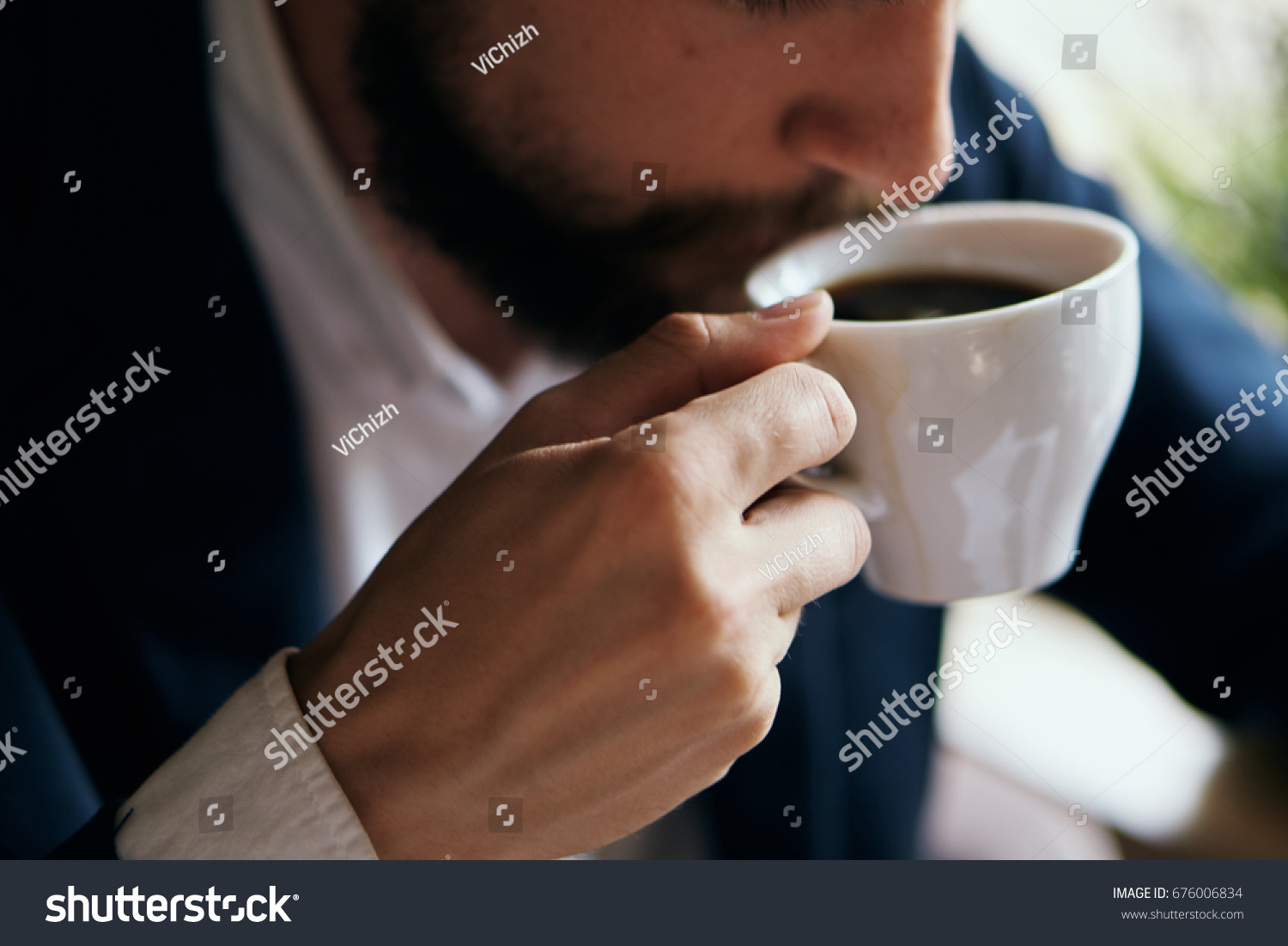 Business man drinking coffee in a cafe                                #676006834
