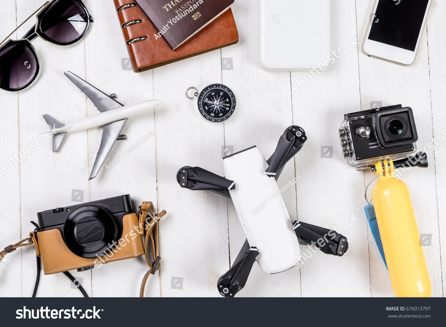 Travel objects and accessories on white wooden, Hi tech gadgets for vacation travel Vlogger and blogger Photography and video footage equipments concept. #676013797