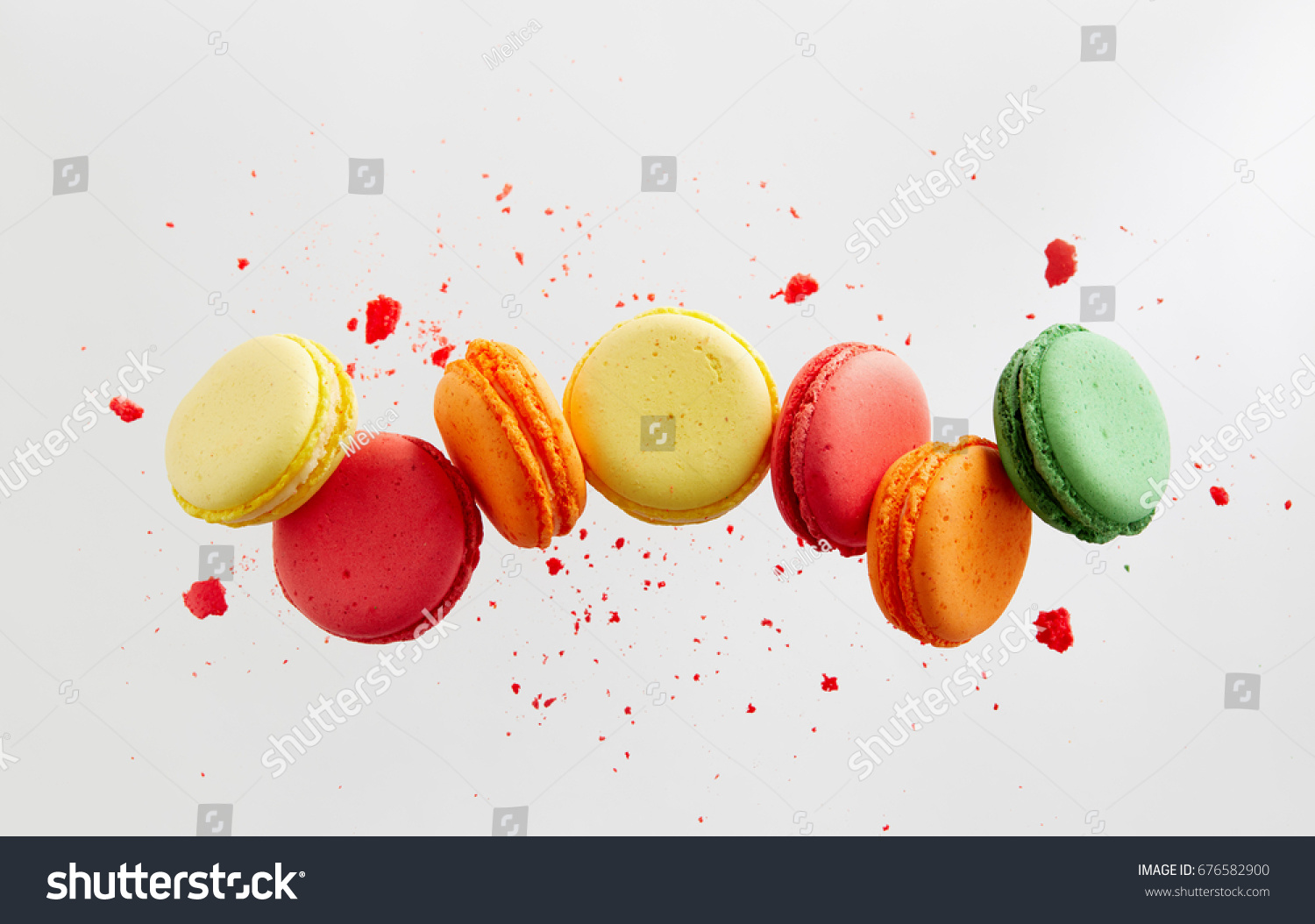 Colorful macarons cakes. Small French cakes. Sweet and colorful french macaroons falling or flying in motion. #676582900