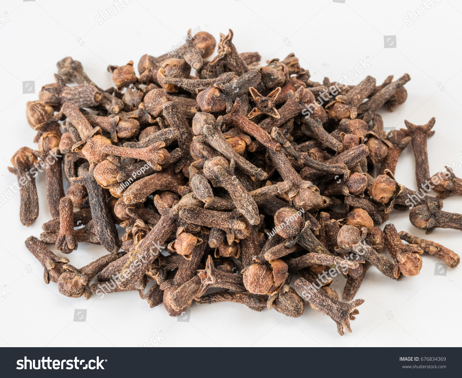 Drying clove spice (Syzygium aromaticum) Cloves are the aromatic flower buds of a tree in the family Myrtaceae. #676834369