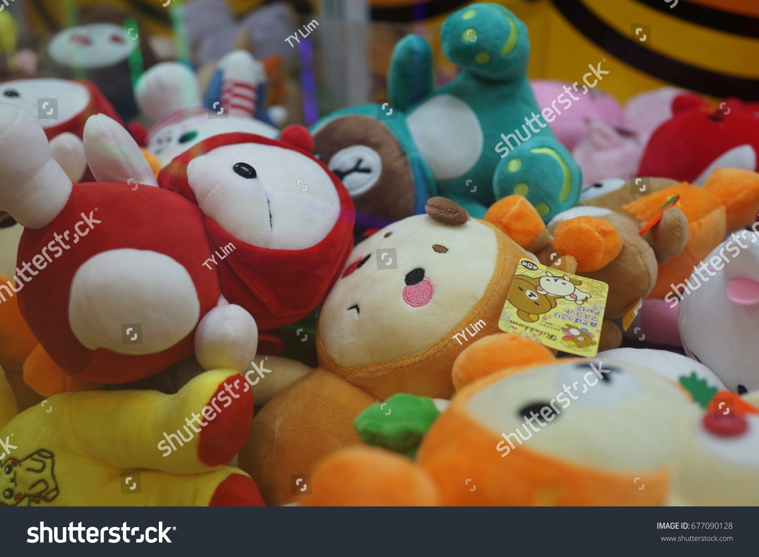 PENANG, MALAYSIA - JULY 13, 2017 : A street claw crane game machine in game center. Claw crane game machines are a frequent sight in japanese cities. #677090128