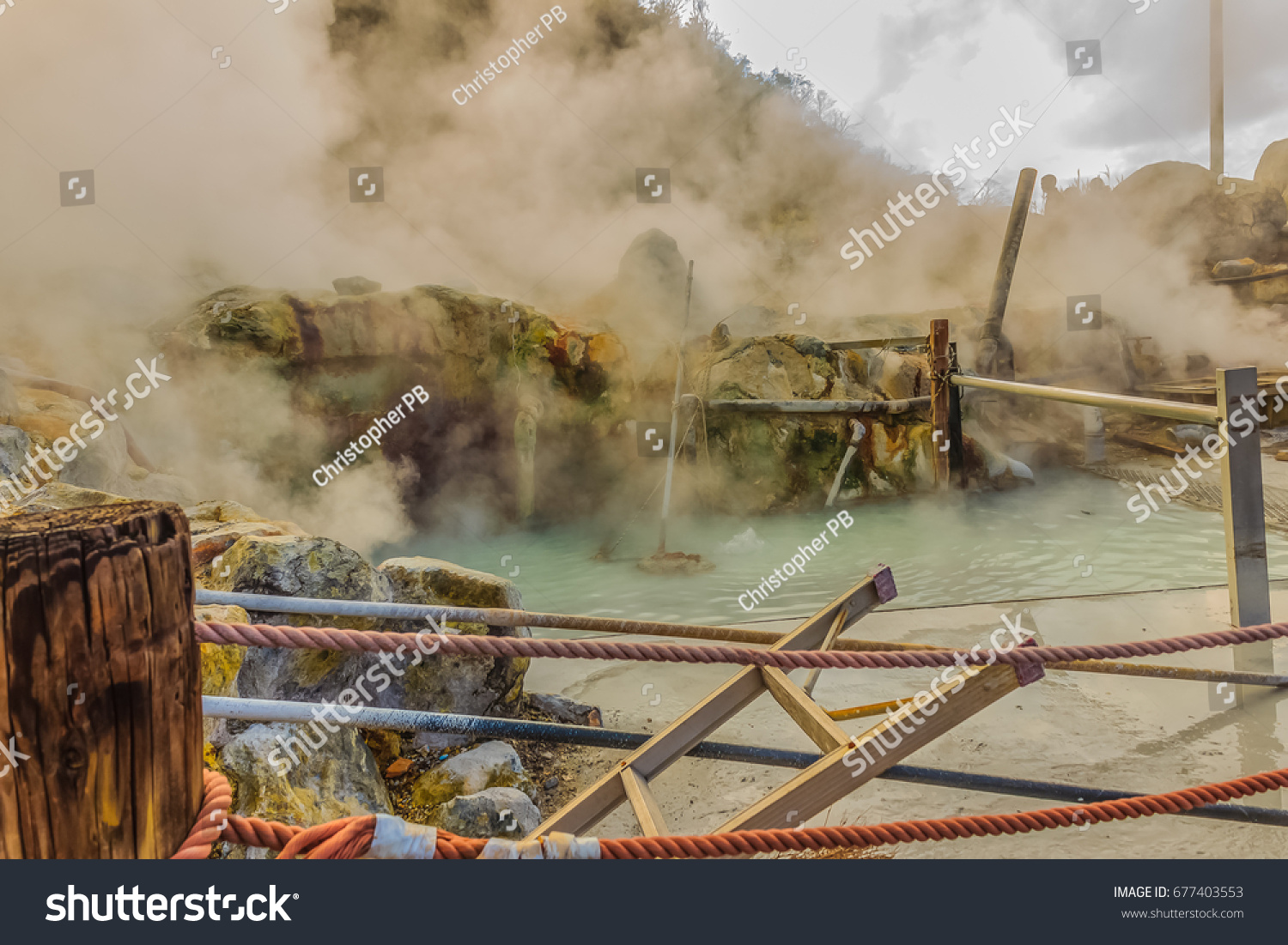 Owakudani hot spring pond with misty and active sulfur vents is popular scenic views, volcano activity and black eggs boiled in hot springs at Hakone, Japan. #677403553