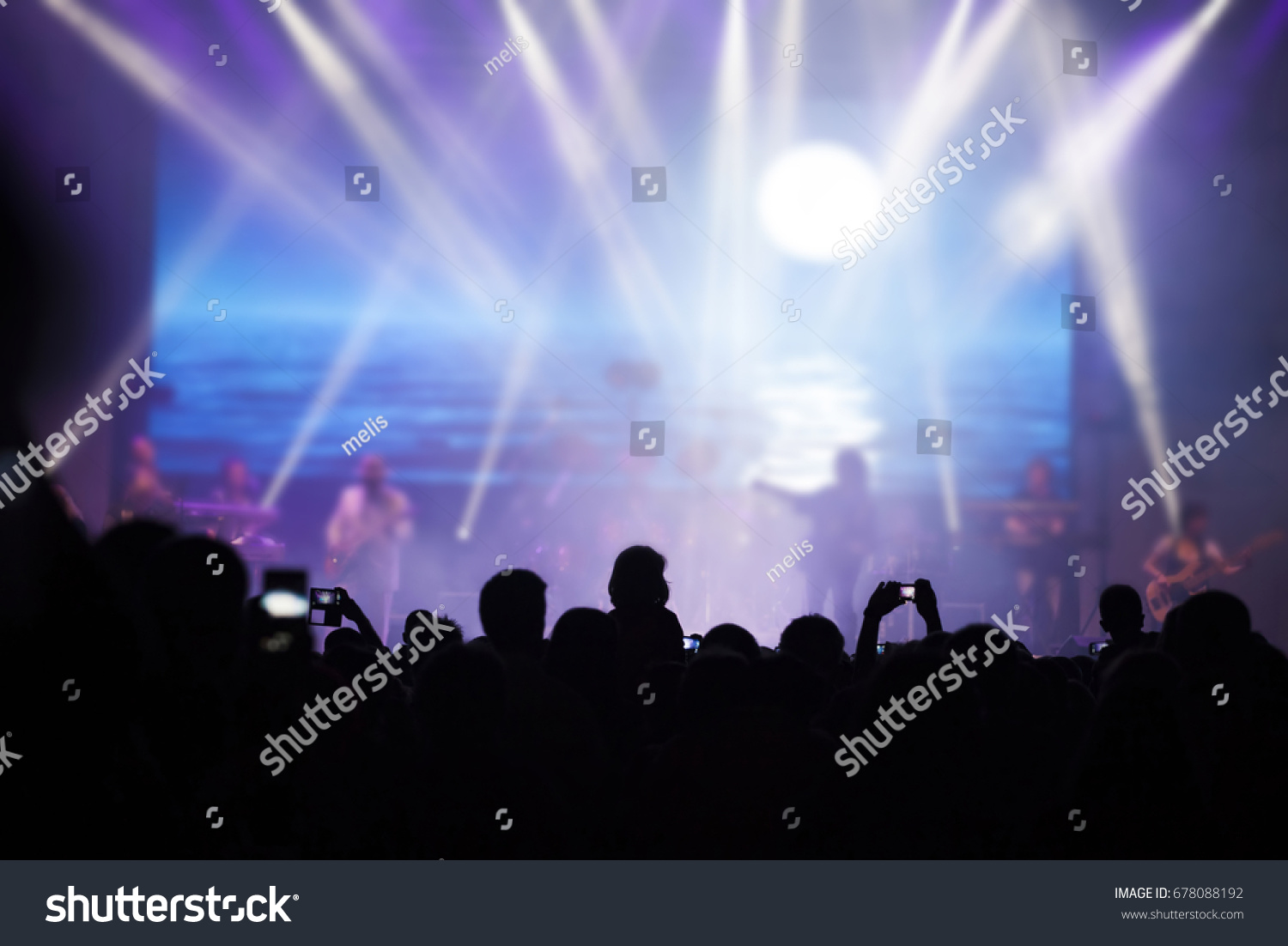 Photo of many people enjoying rock concert, crowd with raised up hands dancing in nightclub, audience applauding to musician band, night entertainment, music festival, happy youth, luxury party #678088192