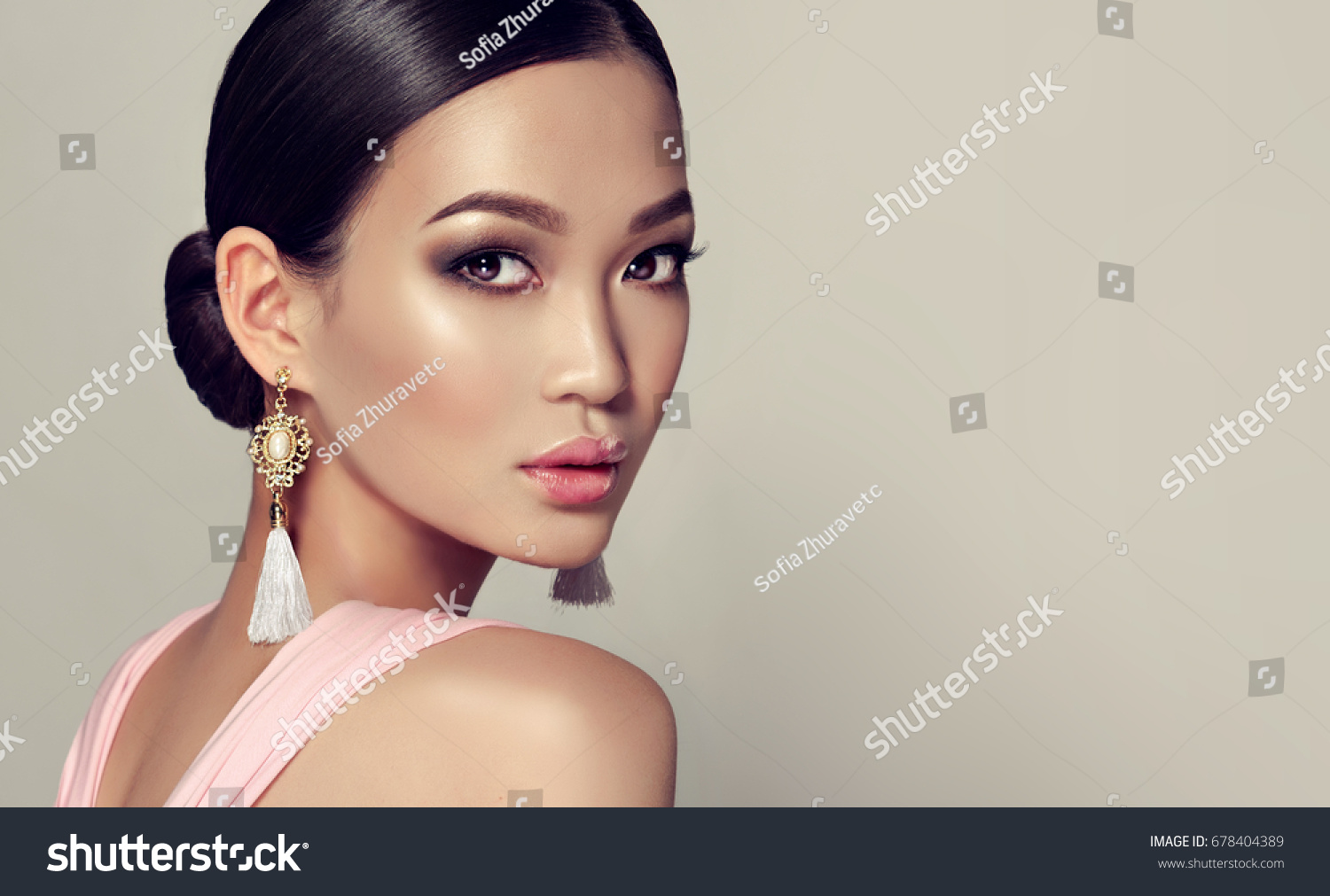 Asian model  fashion girl  with tassel earrings and  pink dress. #678404389