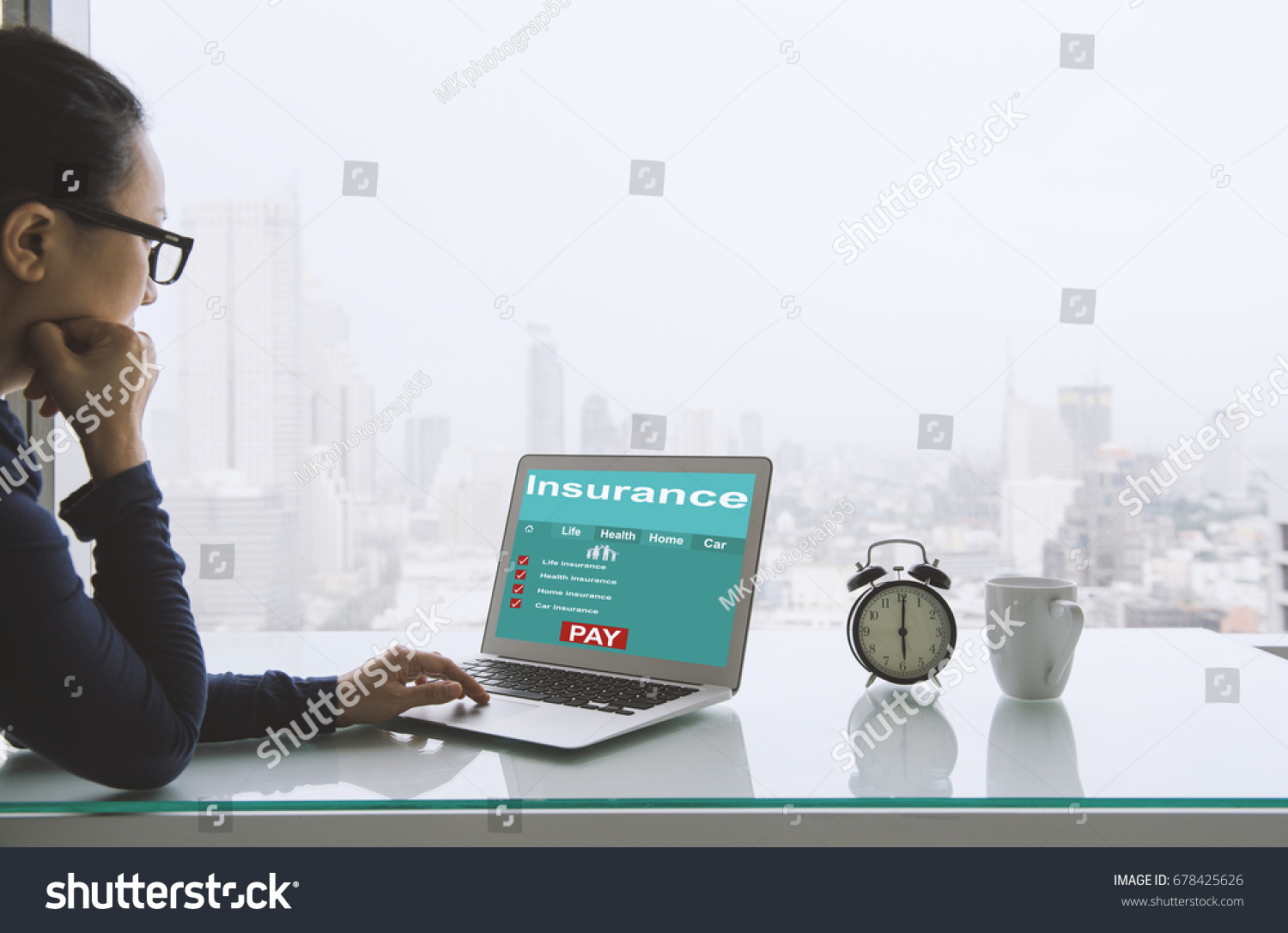 Insurance concept. Women use laptops to search for insurance online on a home office. #678425626