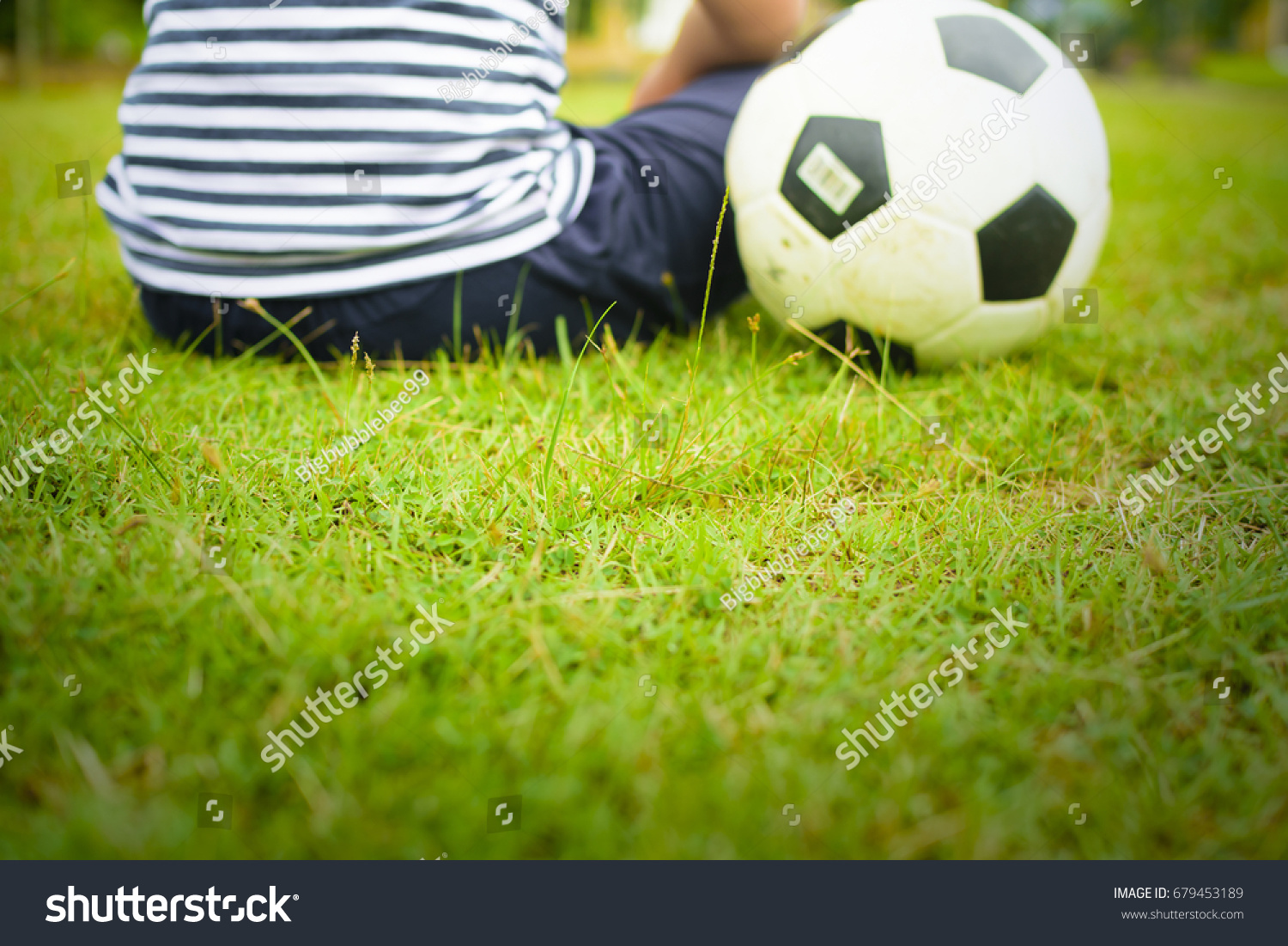 Boy with ball,Or boy with soccer and green grass(focus center of picture) #679453189