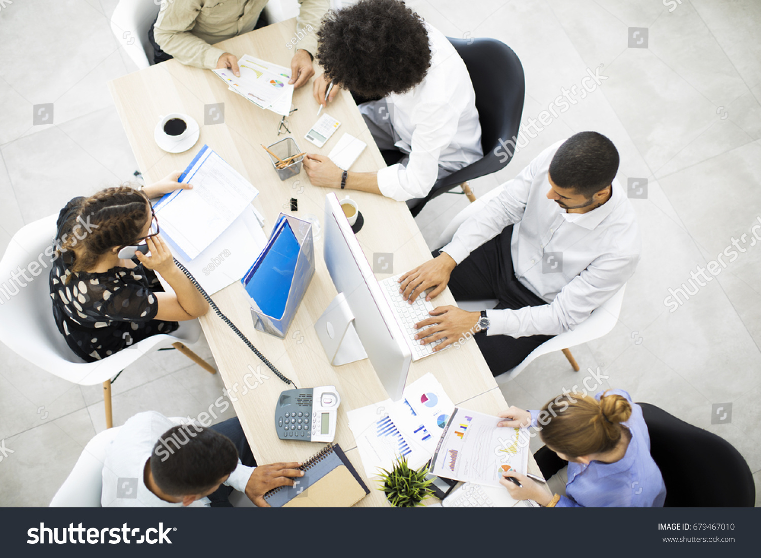 Businesspeople working in office #679467010