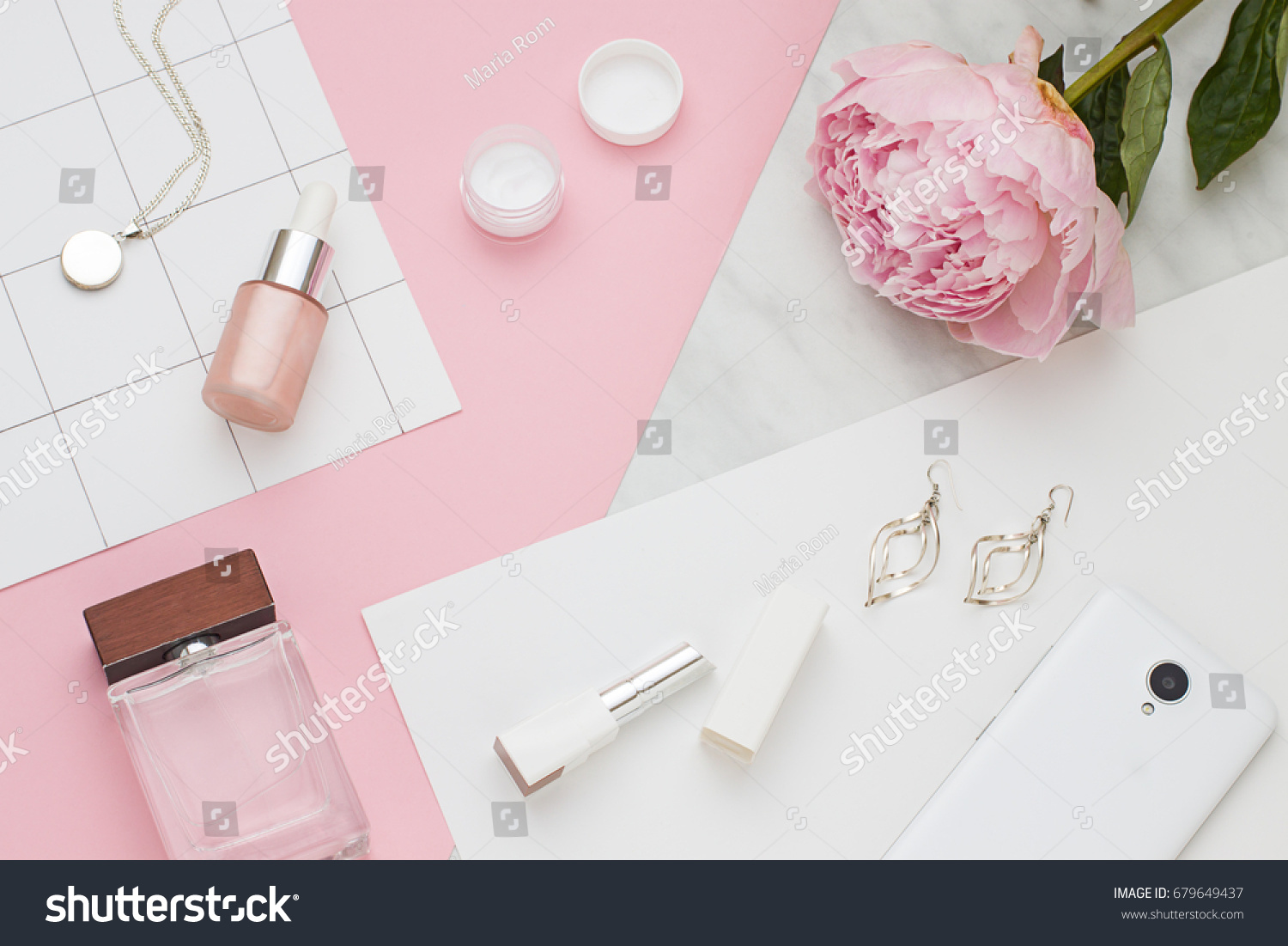 Beauty flat lay with cosmetic bottles, phone and flower. Top view #679649437