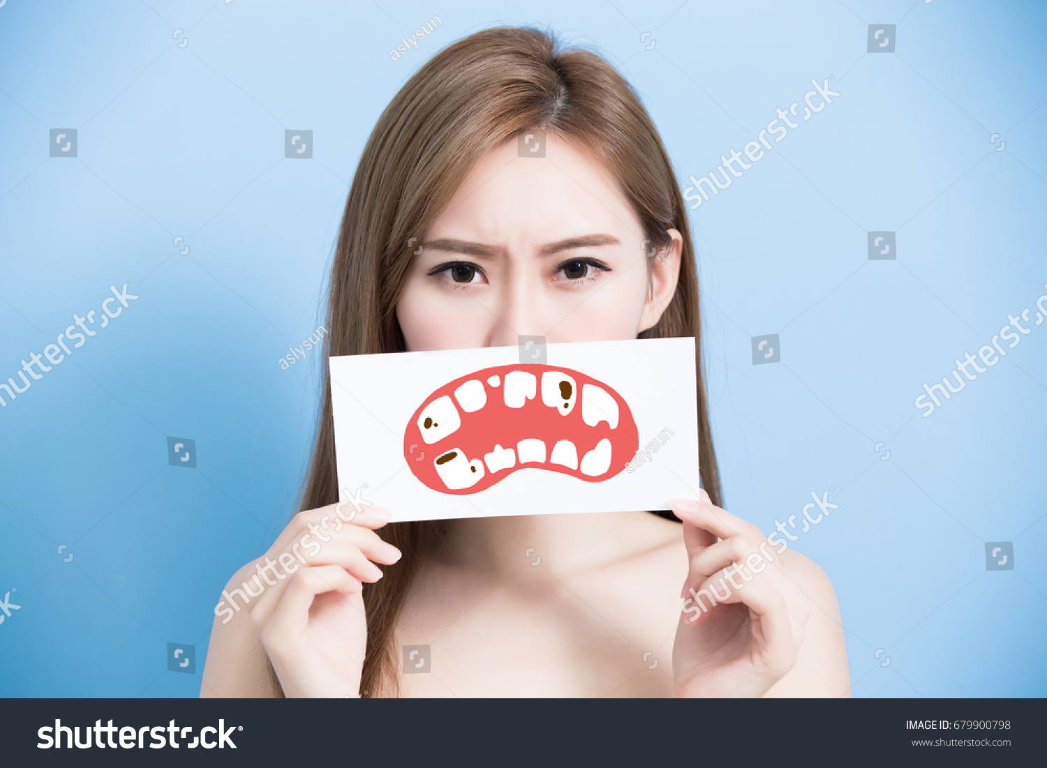 woman take tooth billboard and feel bad on the blue background #679900798