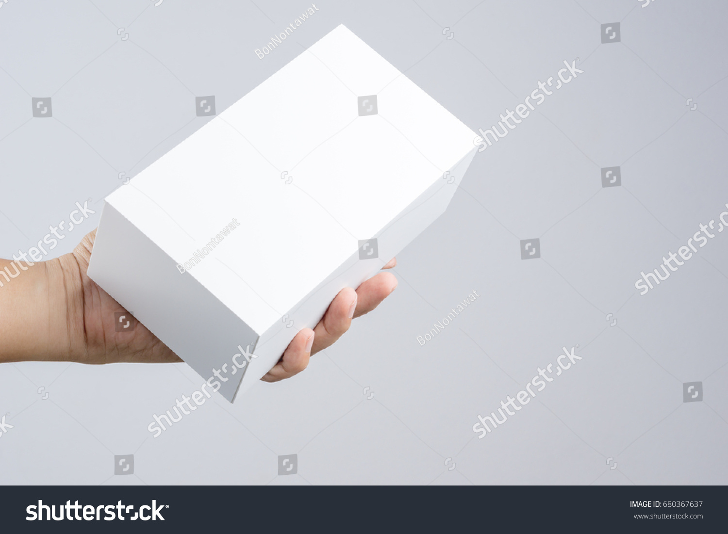 Hand holding blank white box give gift on white background #680367637