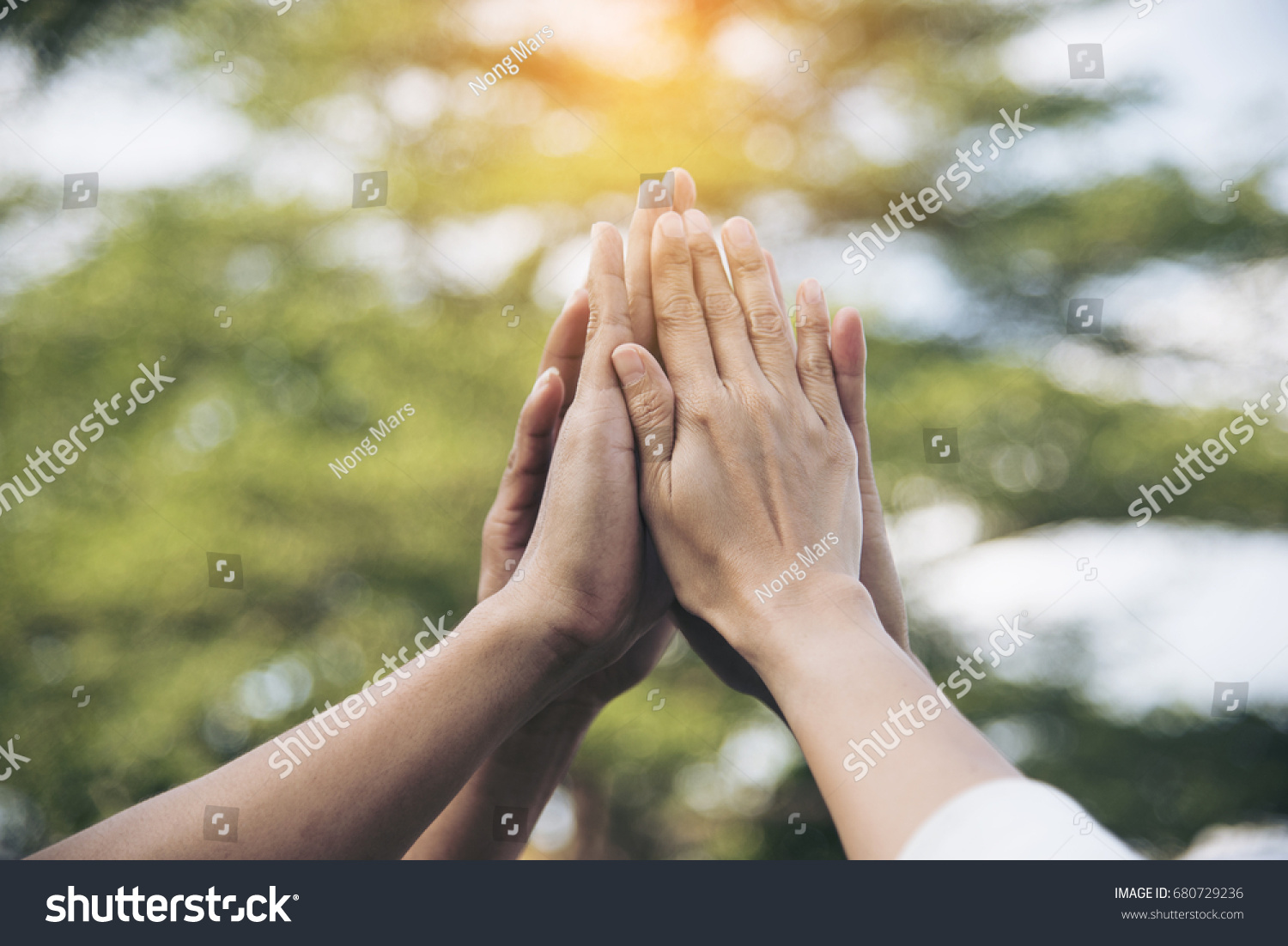 Teamwork high five as team together hands air greeting  power tag team. Group of diversity people multiethnic 
unity togetherness in Volunteer community. Collaboration Business Team success concept. #680729236