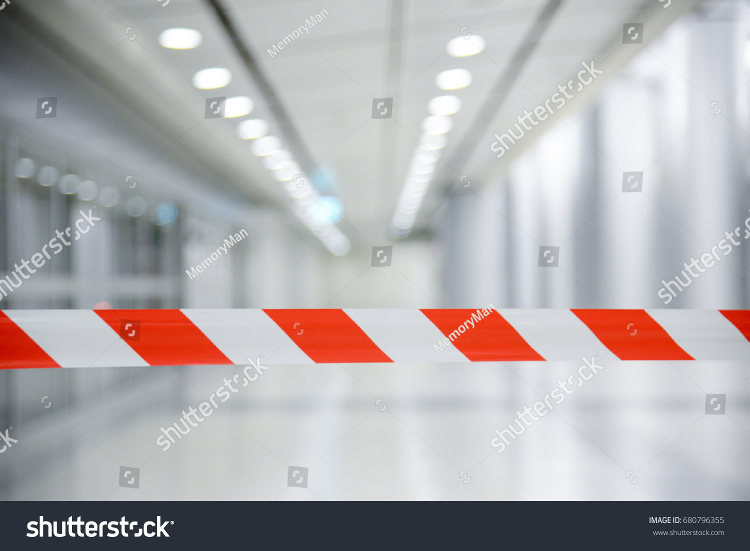 Red and White Lines of barrier tape. At subway station of airport background.Red White warning tape pole fencing is protects for No entry
