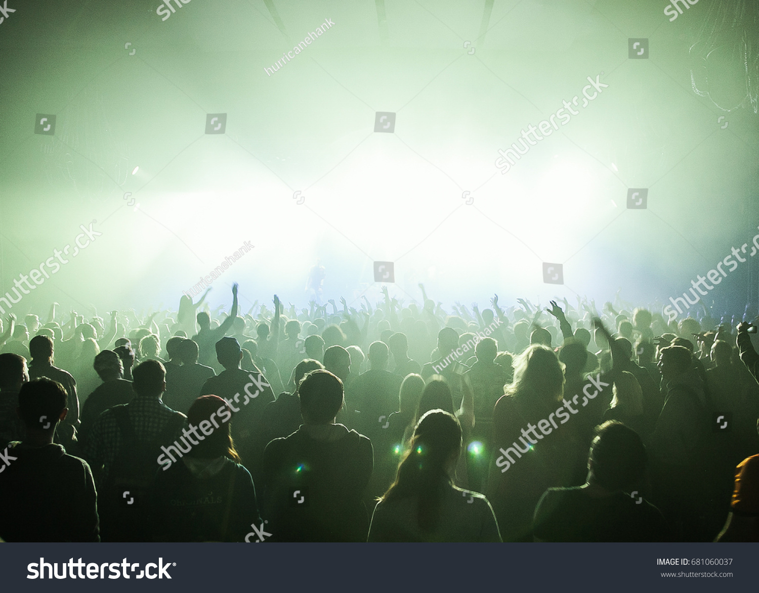 MOSCOW-20 FEBRUARY,2015: Crowded dancefloor in nightclub.Big live music show in the club.People have fun on concert.Big crowd on sold out festival.Rave party people on dance floor.Techno music party #681060037